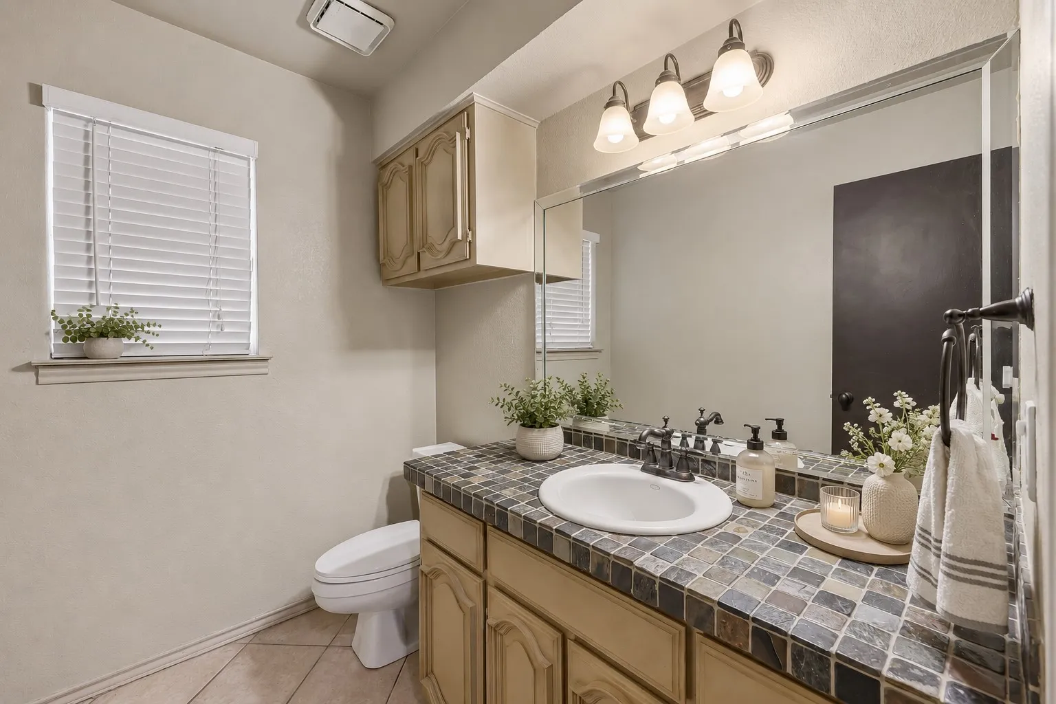 Bathroom featuring a white toilet, window with blinds, recessed lighting, and tiled flooring