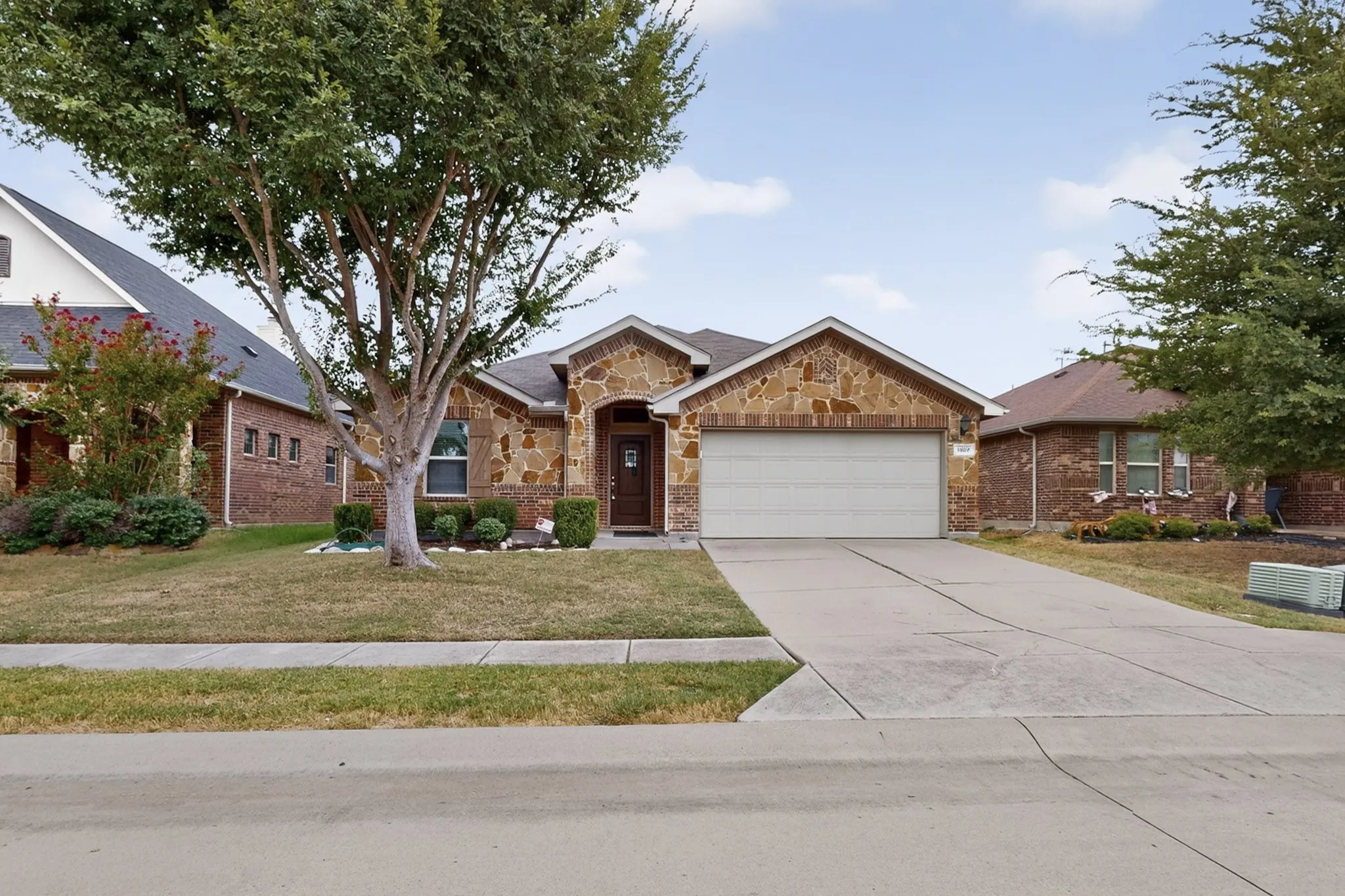 Stone and brick exterior with a two-car garage