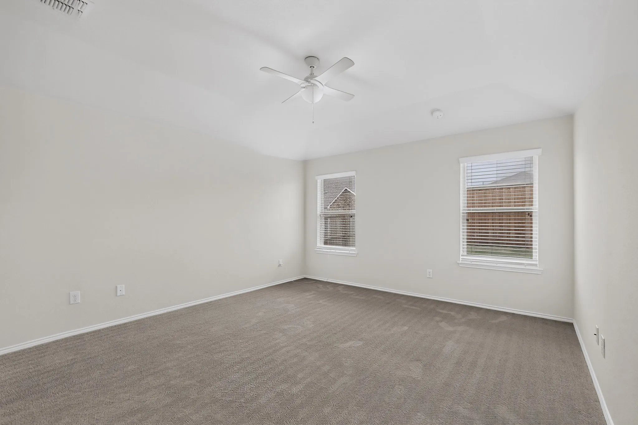 Neutral wall tones with carpeted flooring