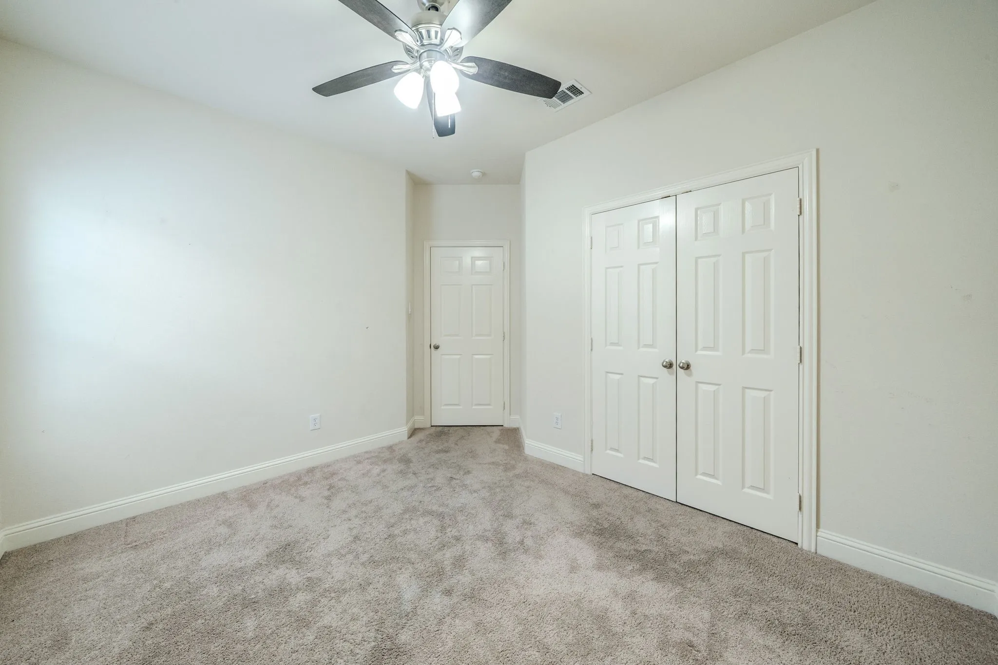 Neutral-toned wall paint and grey carpeting define this room