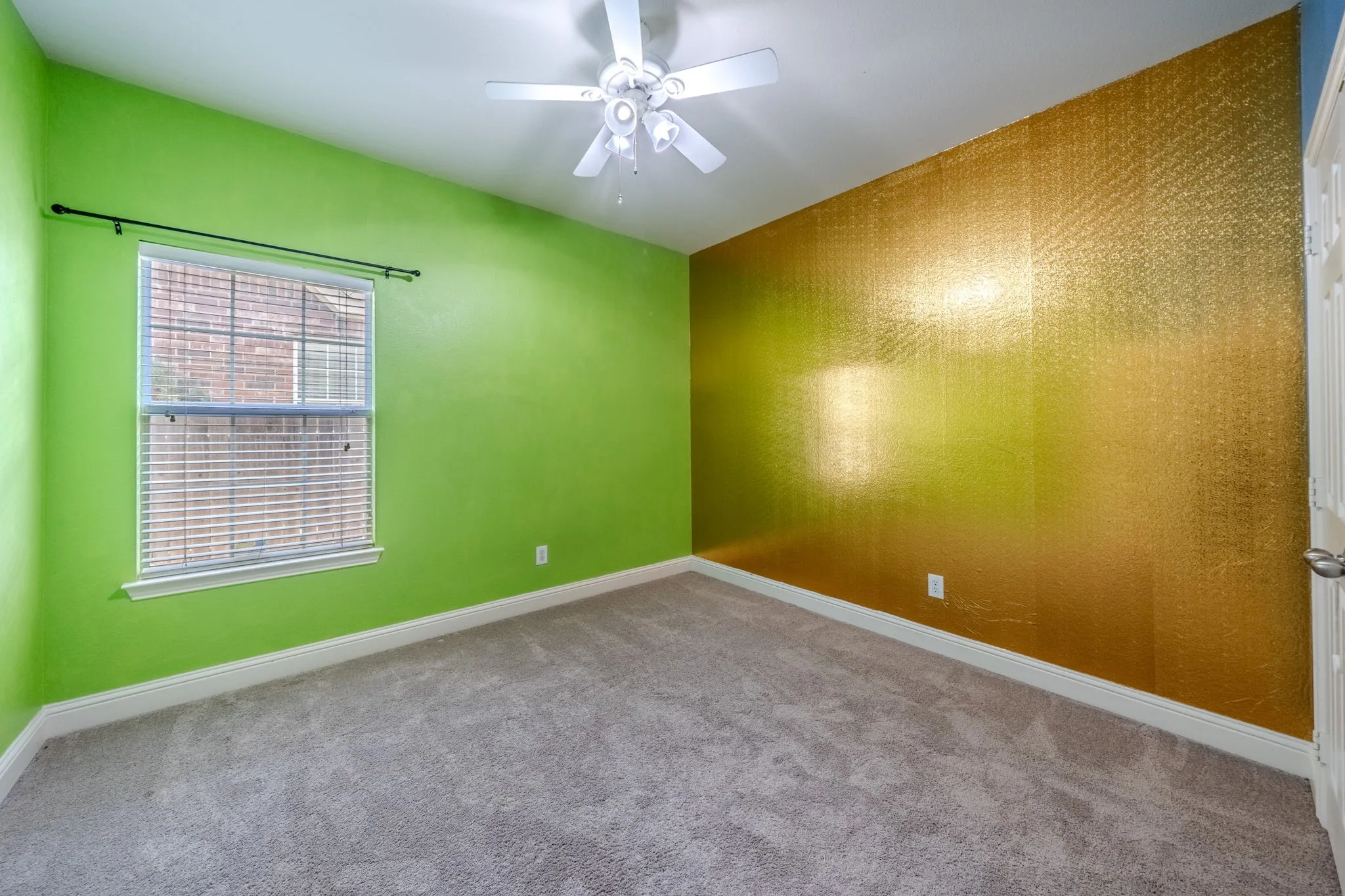 Interior room featuring a white ceiling fan, a window with blinds, and light gray carpeting