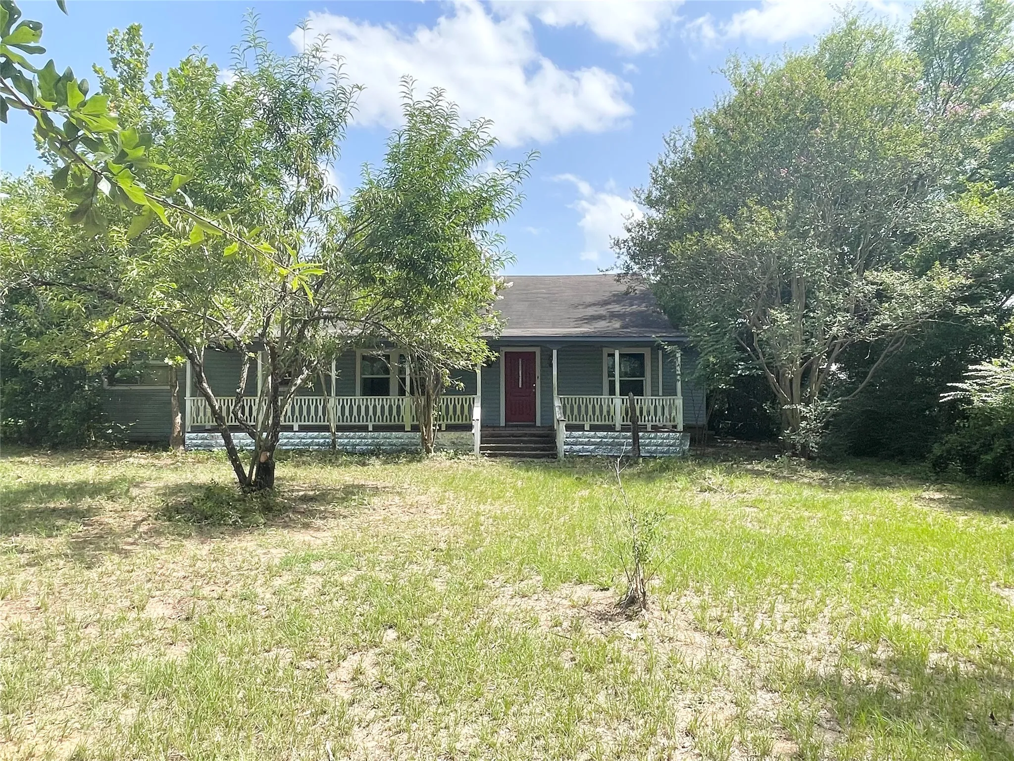 Wide front porch overlooking yard and rest of property