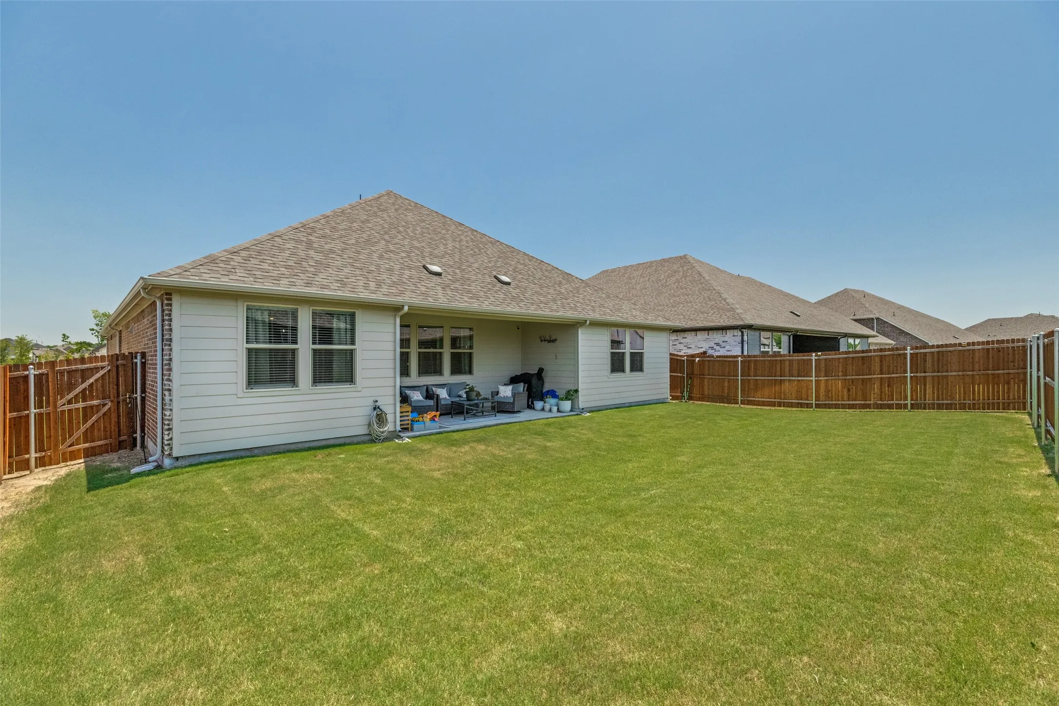 Large yard and covered patio perfect for playing and relaxing