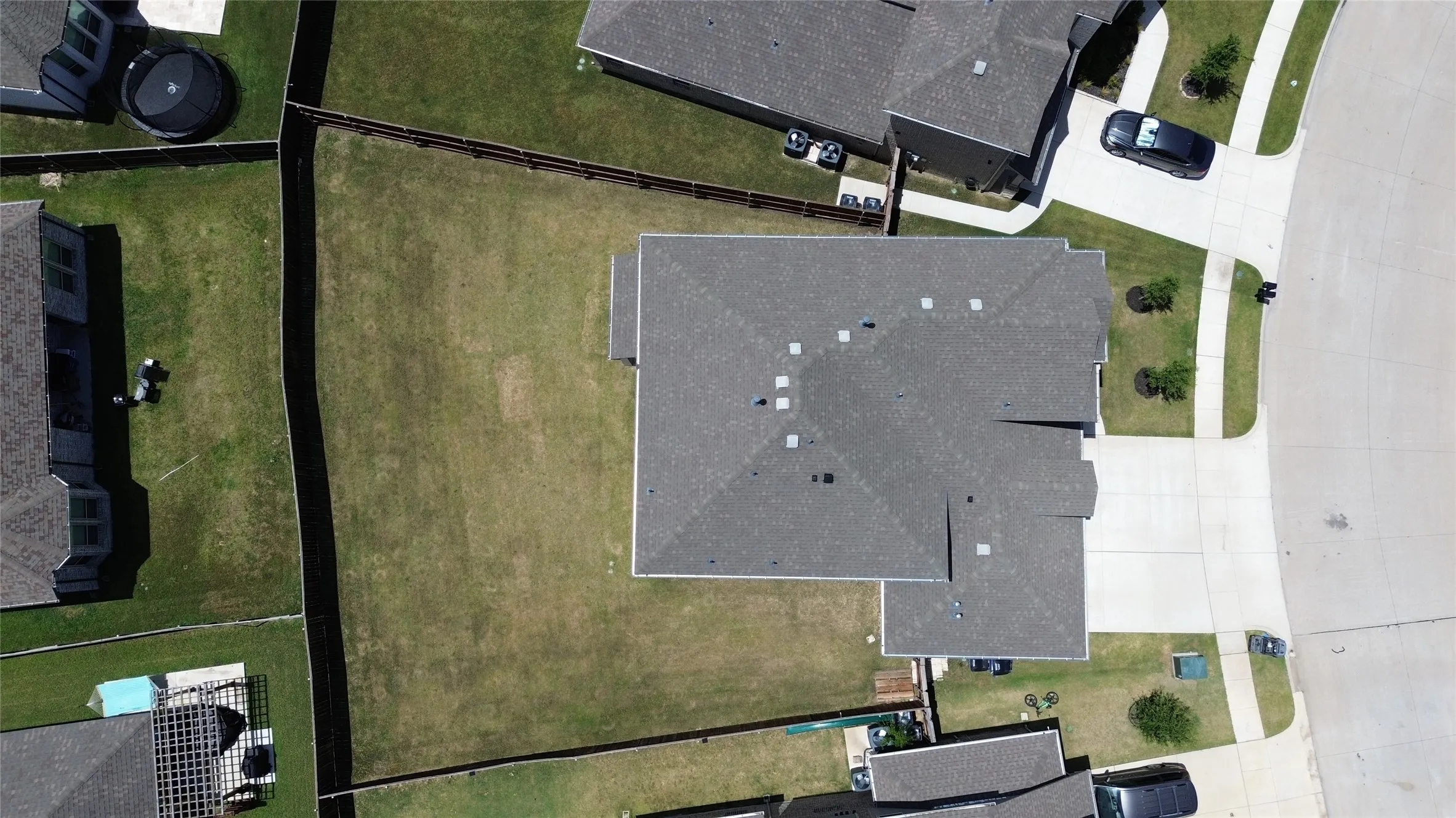 Expansive fenced backyard featuring a substantial lawn area and established perimeter fencing