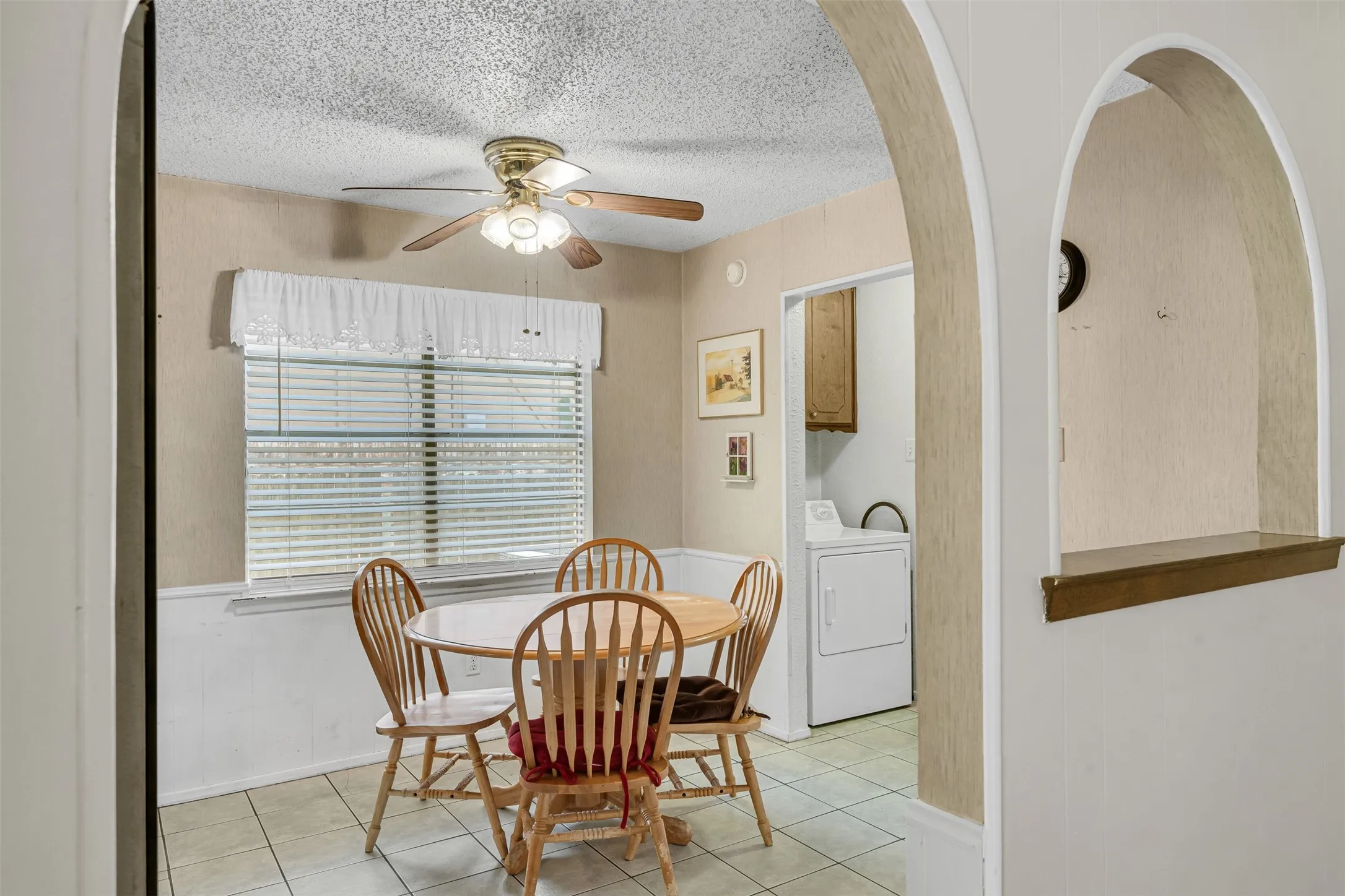 Dining area with tile flooring and a ceiling fan