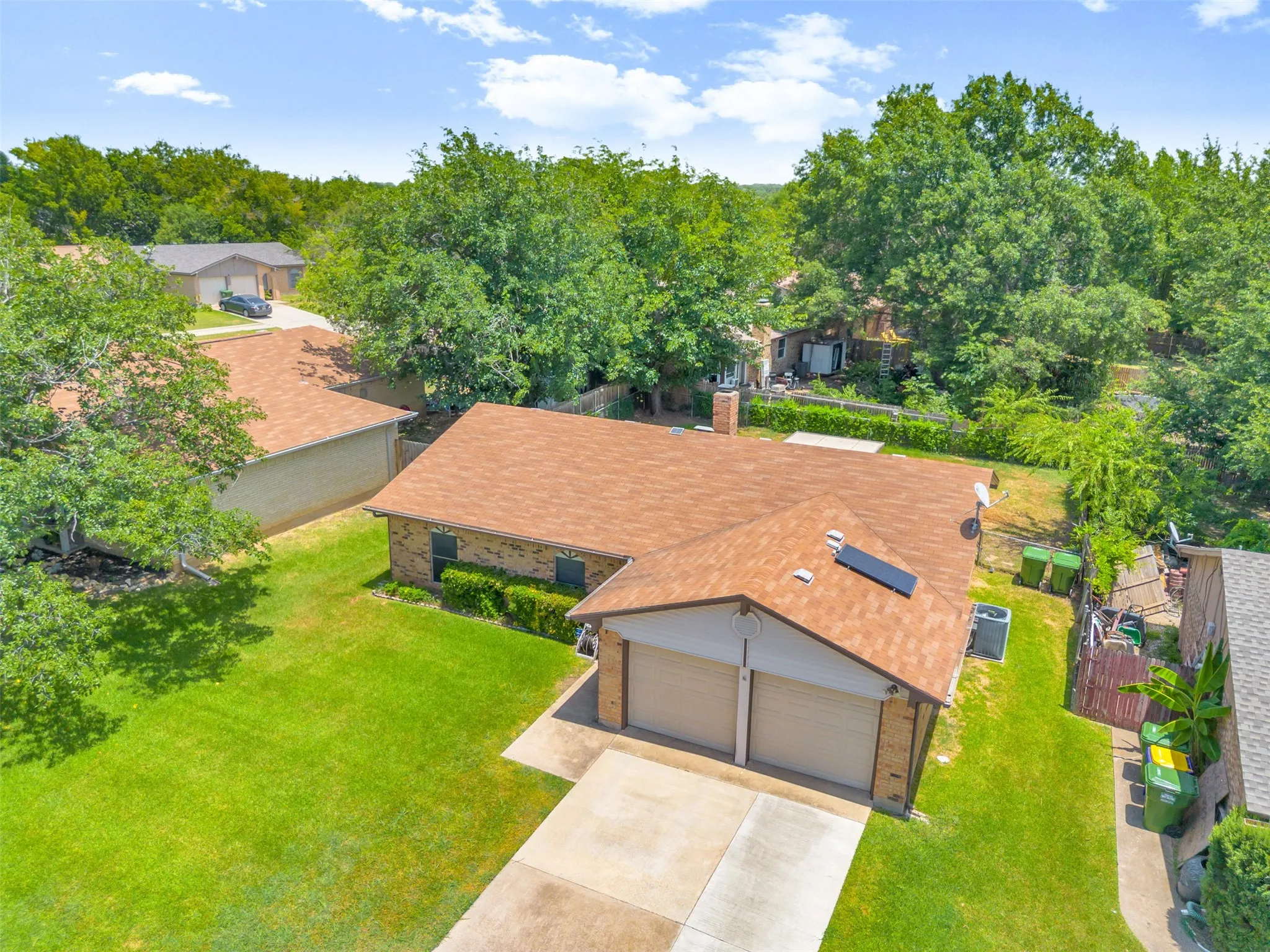 Single-story residence featuring a two-car garage, brick facade, and a shingle roof