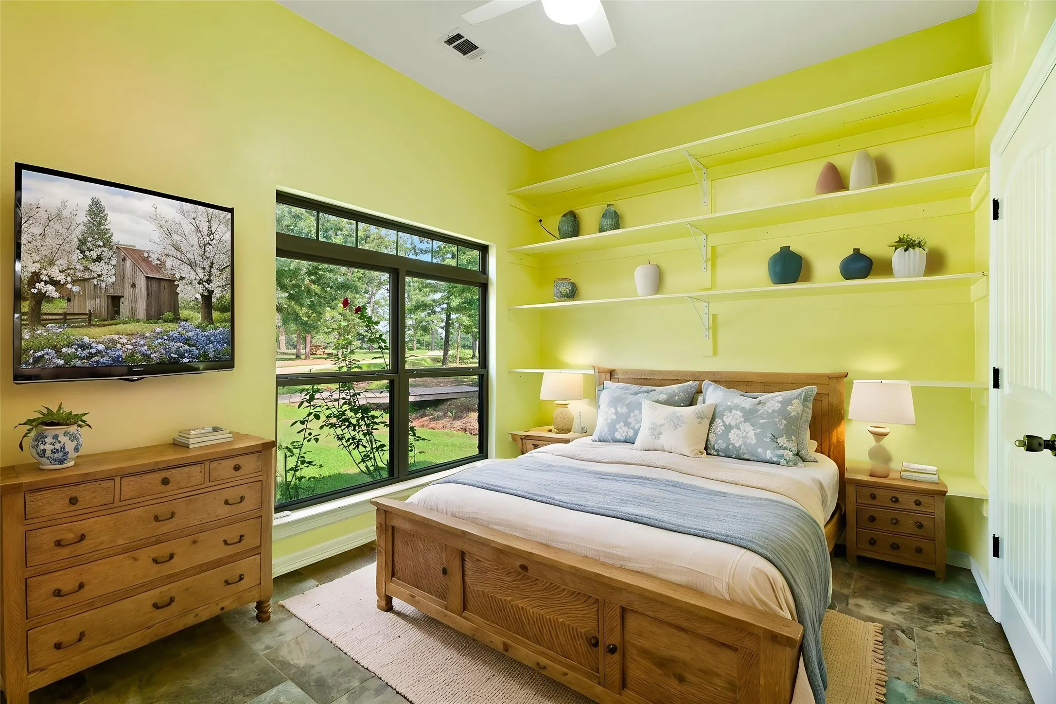 Spacious room featuring a large window with exterior views, built-in shelving, ceiling fan, and recessed lighting