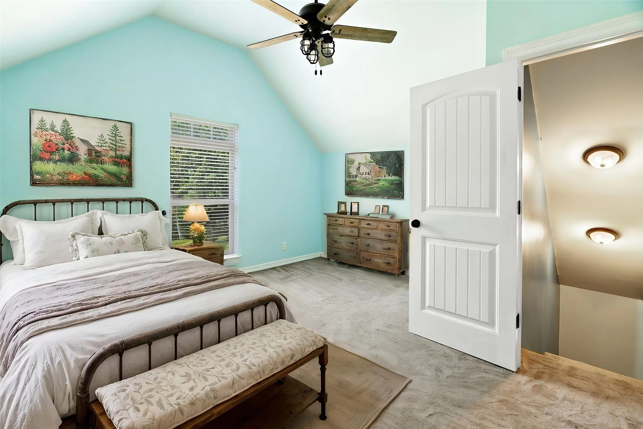 Vaulted ceiling featuring a ceiling fan with wood-finish blades, wood-finish flooring, a window with blinds, and a white panel door