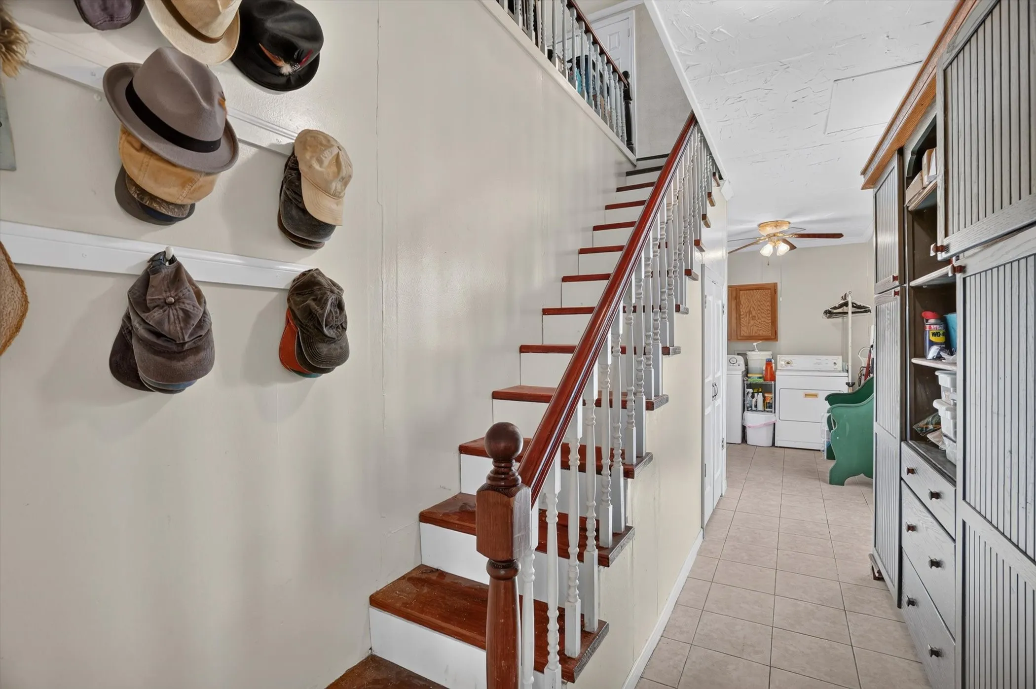 Two-story staircase featuring wood-finish treads and white balusters
