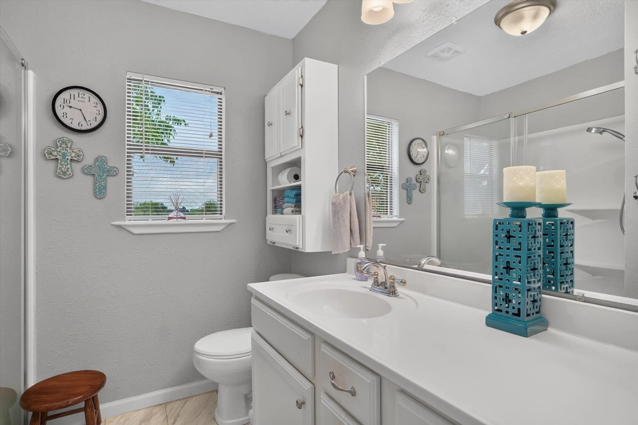 Bathroom with a single vanity, integrated sink, and white countertop