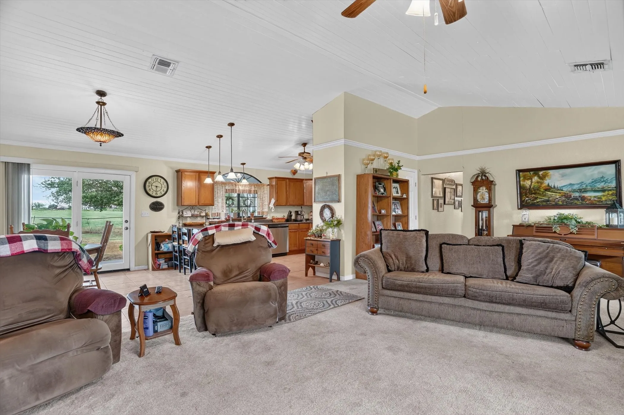 Open concept living area with vaulted planked ceilings