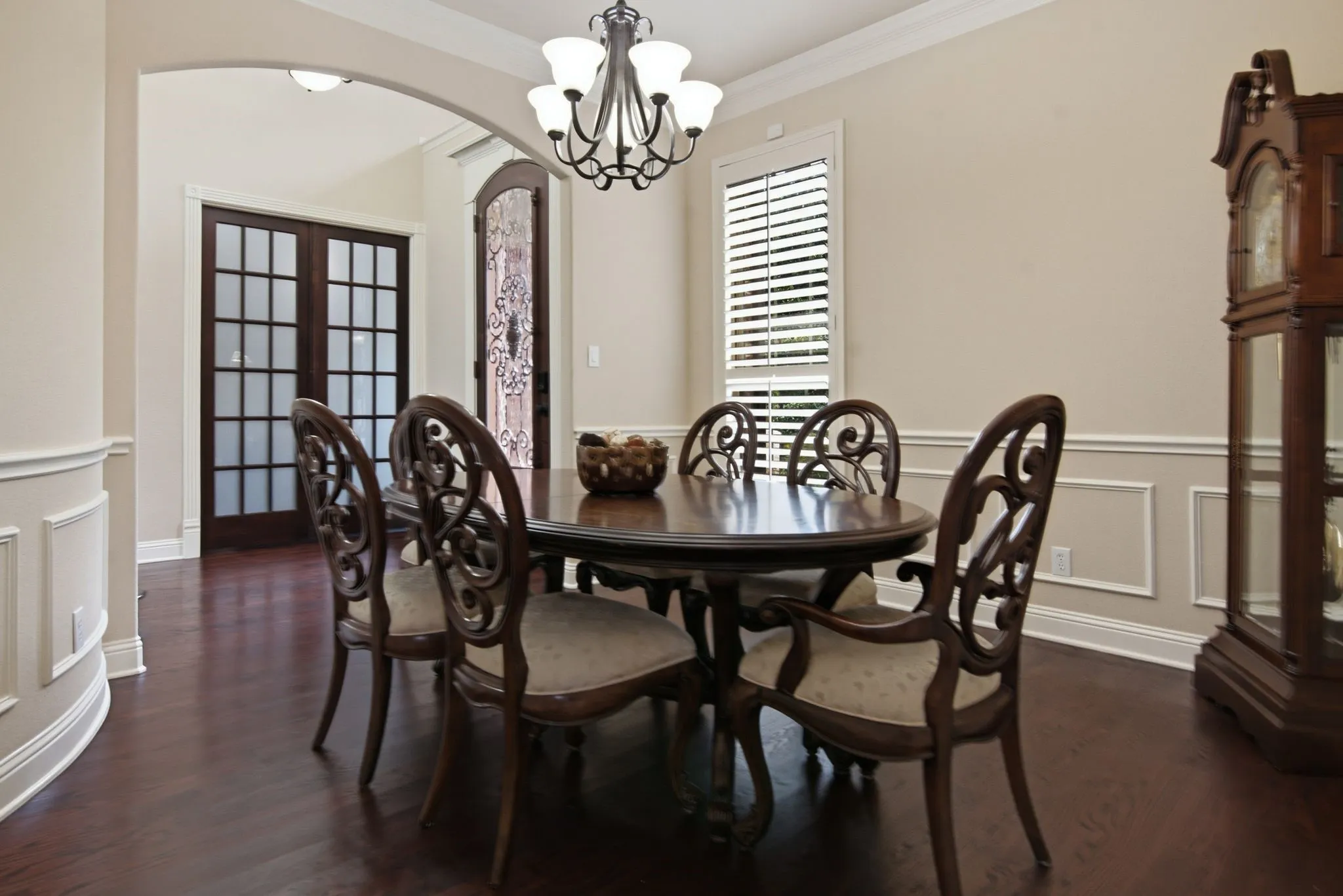 Formal dining room just off the entry and features wood floors, chair rail, crown molding and inviting chandelier.