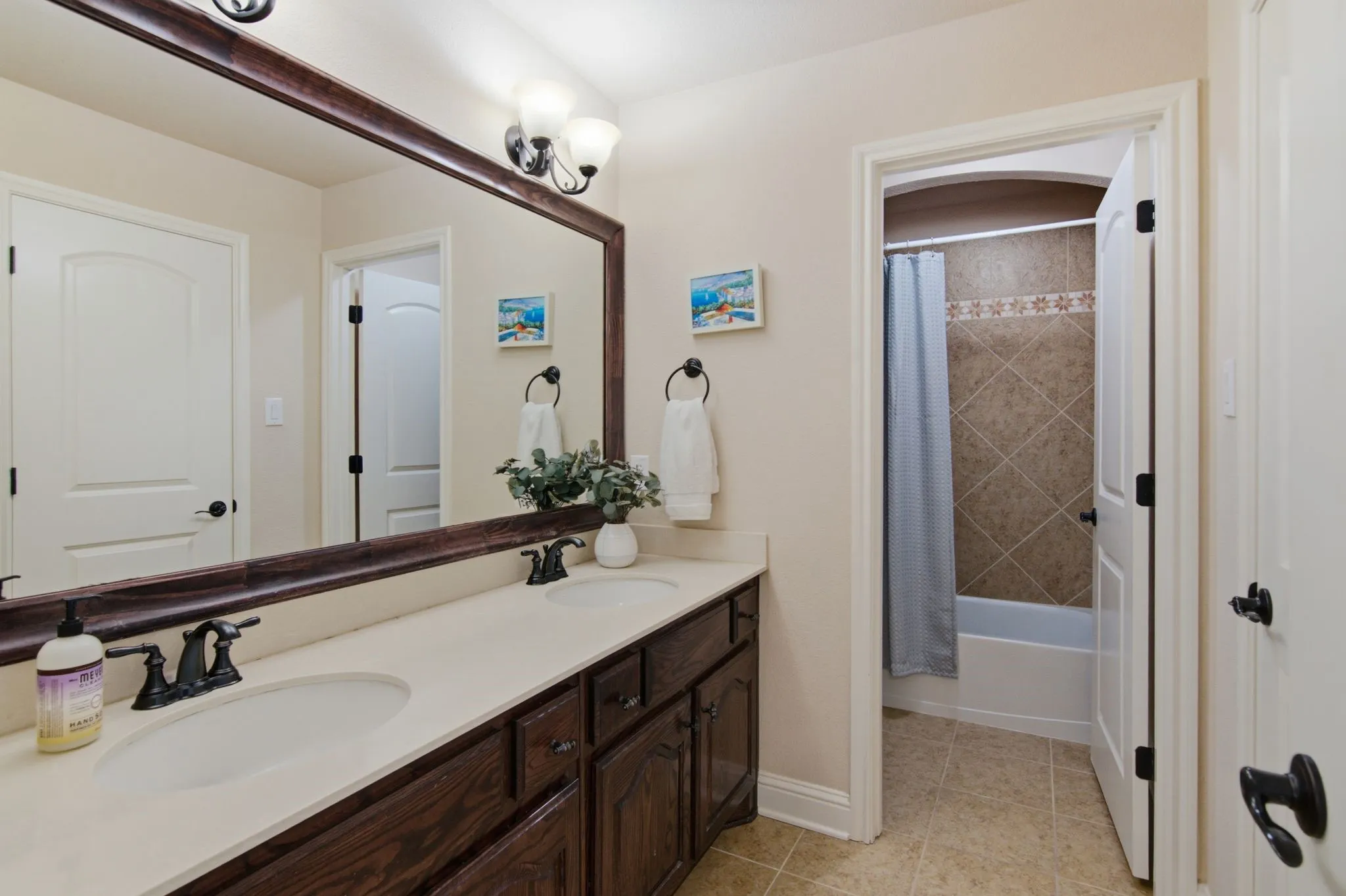 This bath is nestled between two secondary bedrooms and has dual sinks and separate shower/toilet area.