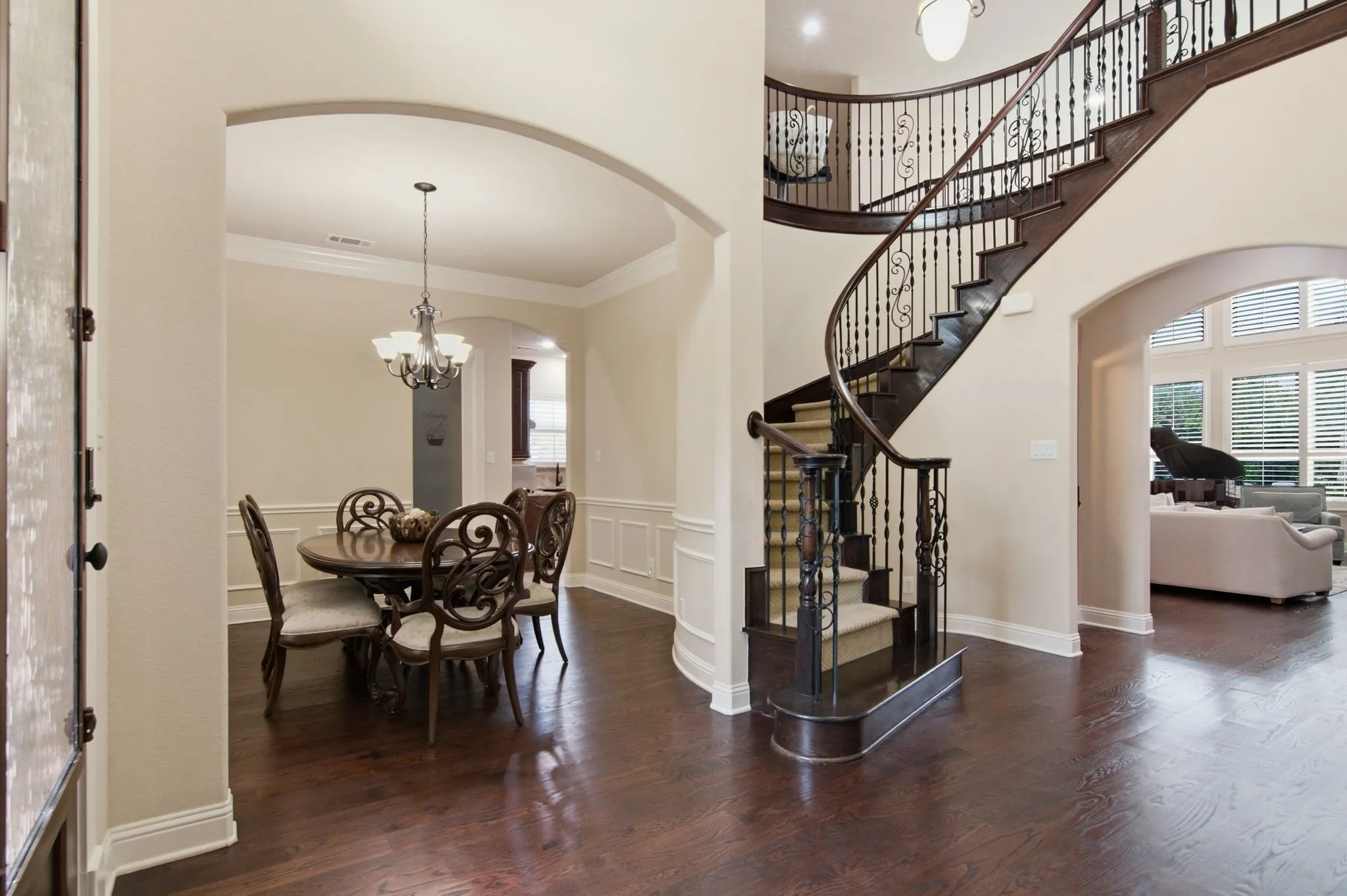Stunning entry with soaring ceiling, and iron stair case.