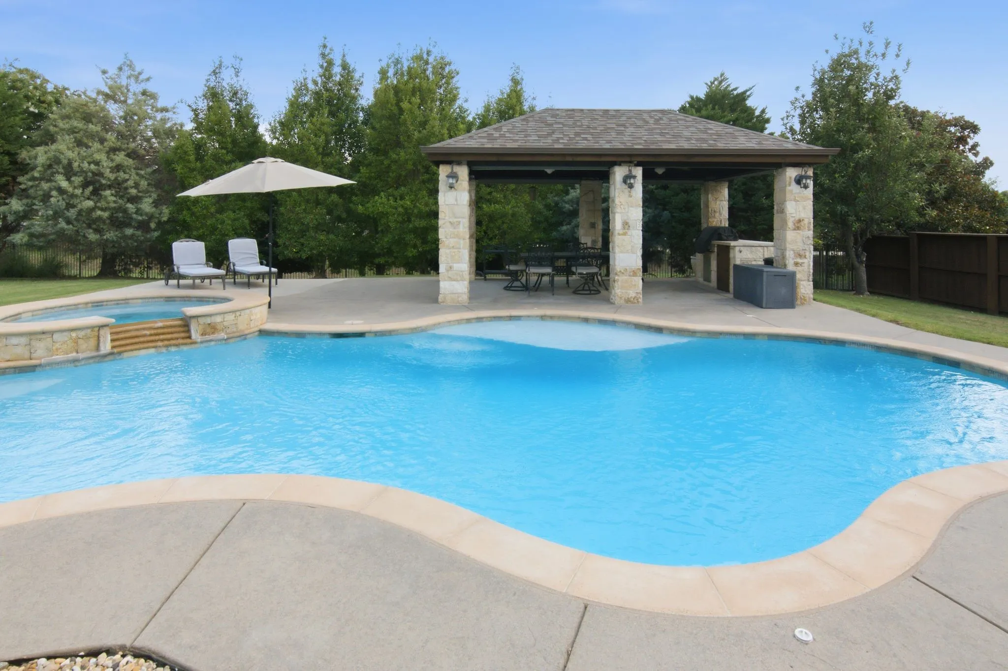 This gorgeous pool has customized Paramount in-floor cleaning system.  No need for a pool sweep or robot.