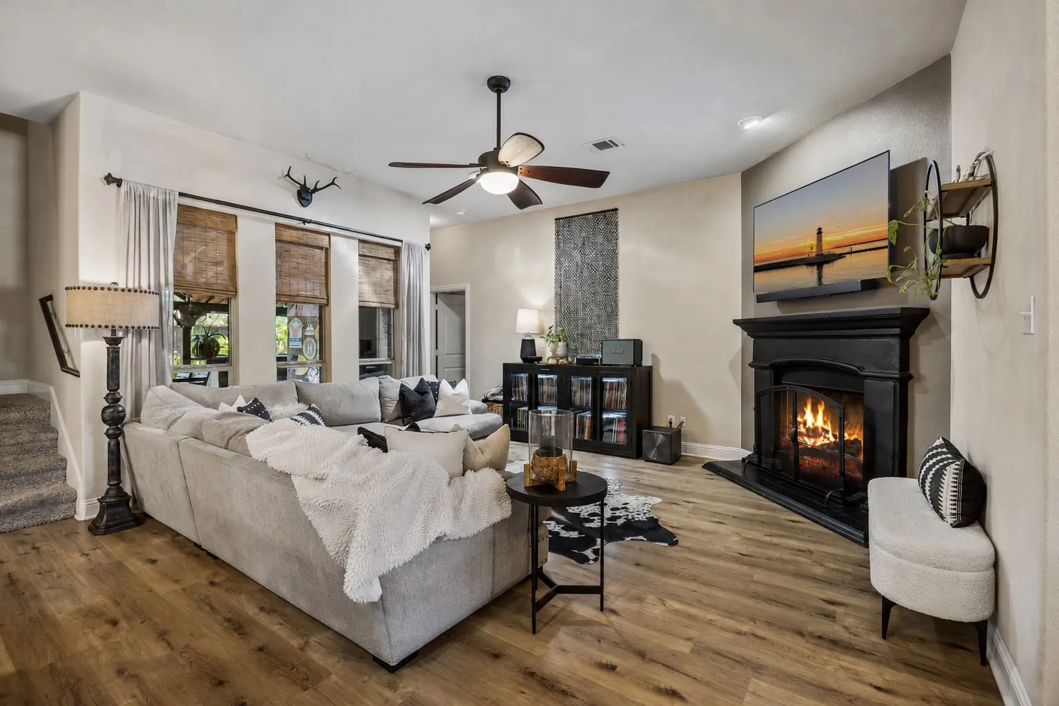 Spacious family room over looking the oasis of a backyard with a gas fireplace.