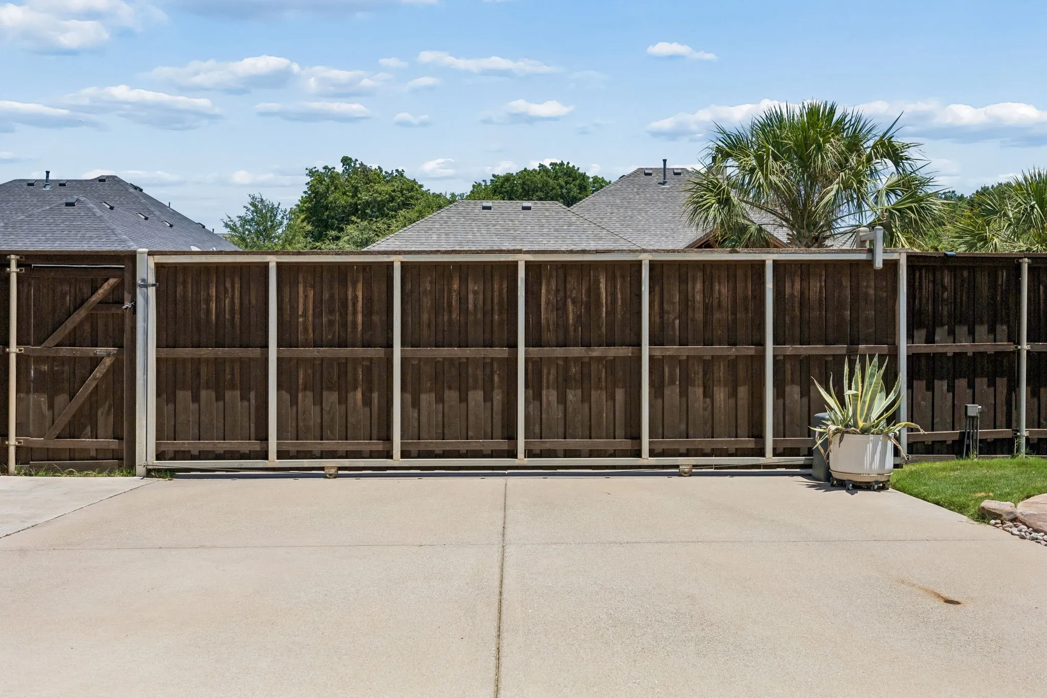 Enclosed by an electric gate, this flat driveway is great for play, extending your backyard and offering the most private outdoor living experience.