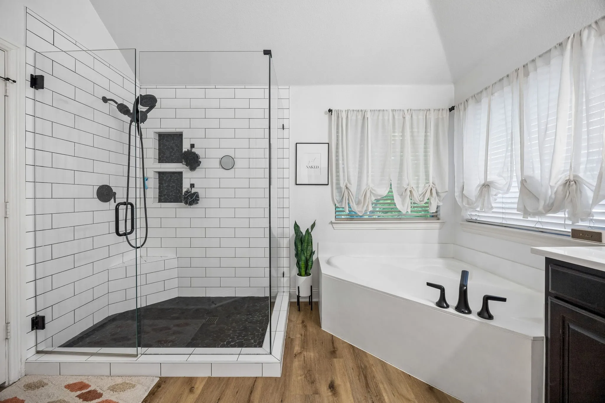 Updated in 2022, this primary bath offers a stunning shower, dual sinks, a soaking tub, separate water closet and a spacious walk-in closet.