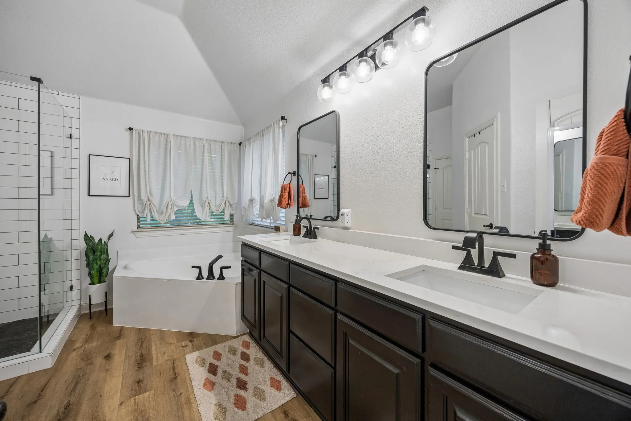 Updated in 2022, this primary bath offers a stunning shower, dual sinks, a soaking tub, separate water closet and a spacious walk-in closet.