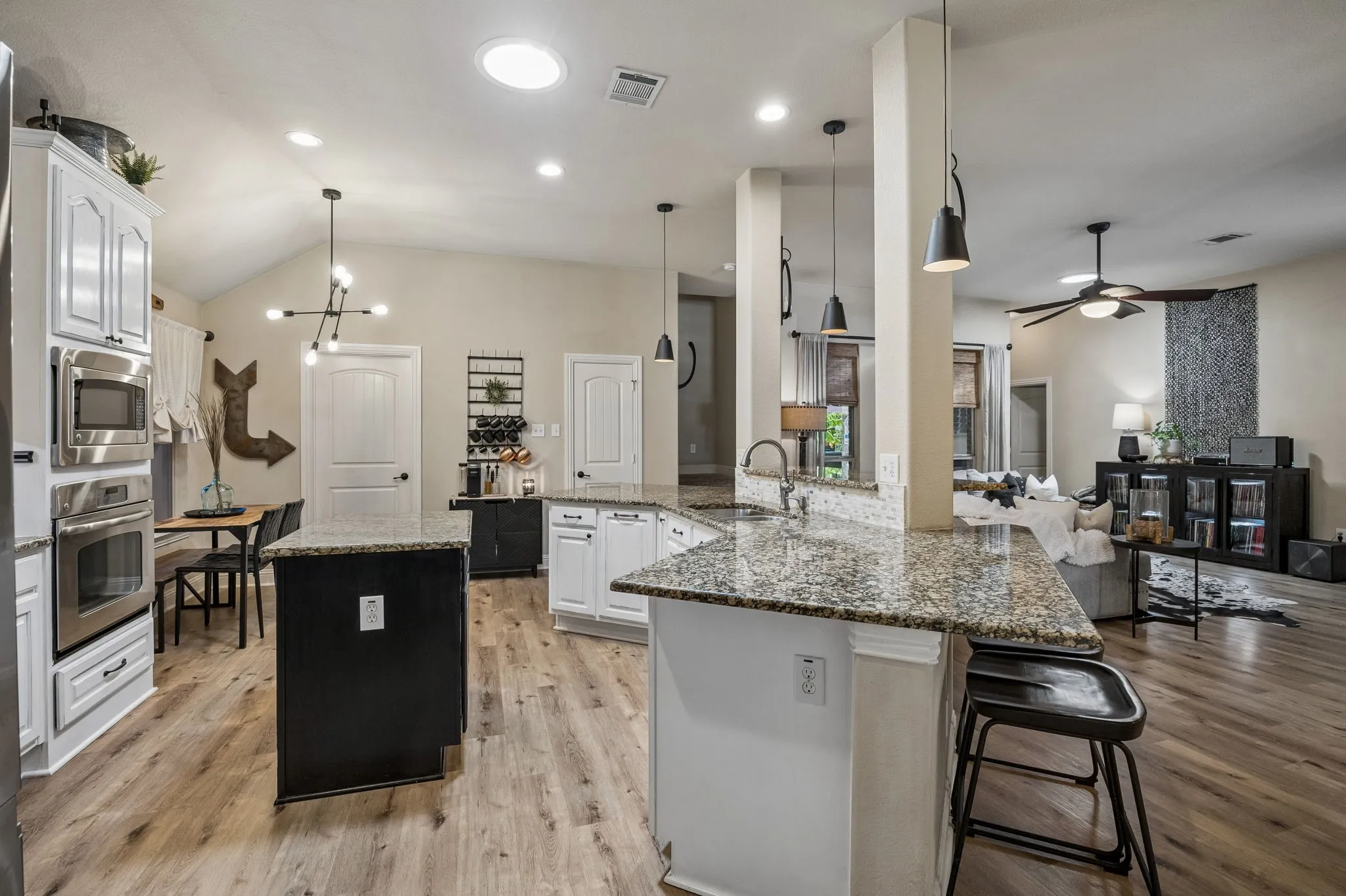 Gas range. Built in oven and microwave. Kitchen island and granite counters...this kitchen has it all!