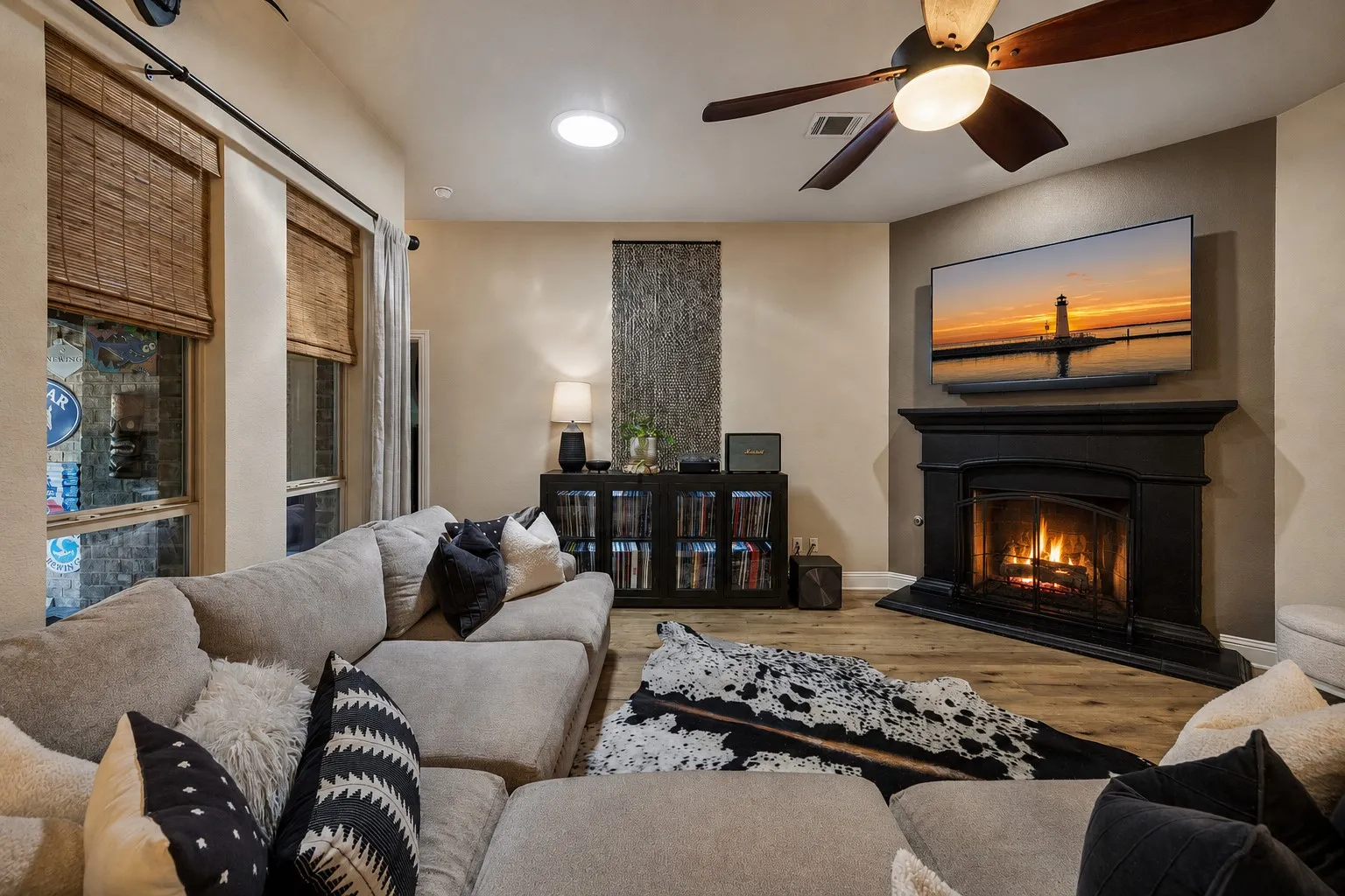 Spacious family room over looking the oasis of a backyard with a gas fireplace.