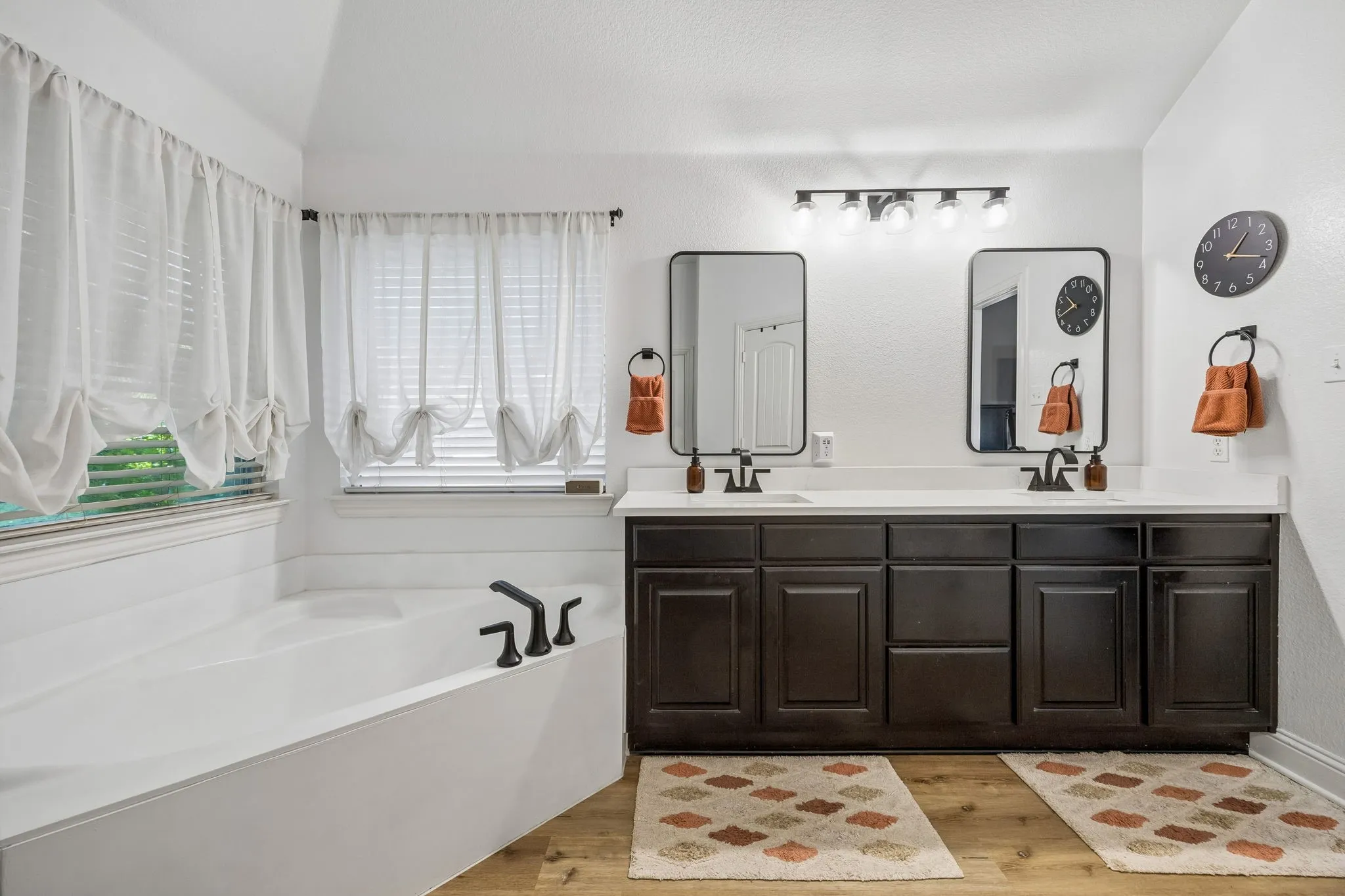 Updated in 2022, this primary bath offers a stunning shower, dual sinks, a soaking tub, separate water closet and a spacious walk-in closet.