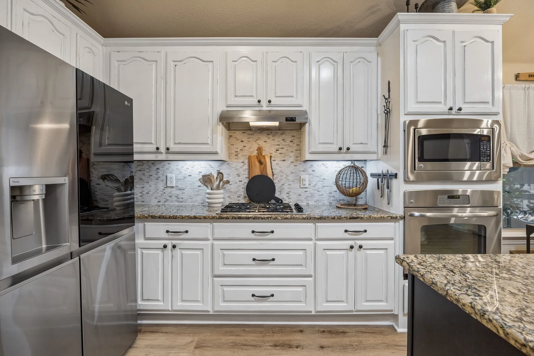 Gas range. Built in oven and microwave. Kitchen island and granite counters...this kitchen has it all!
