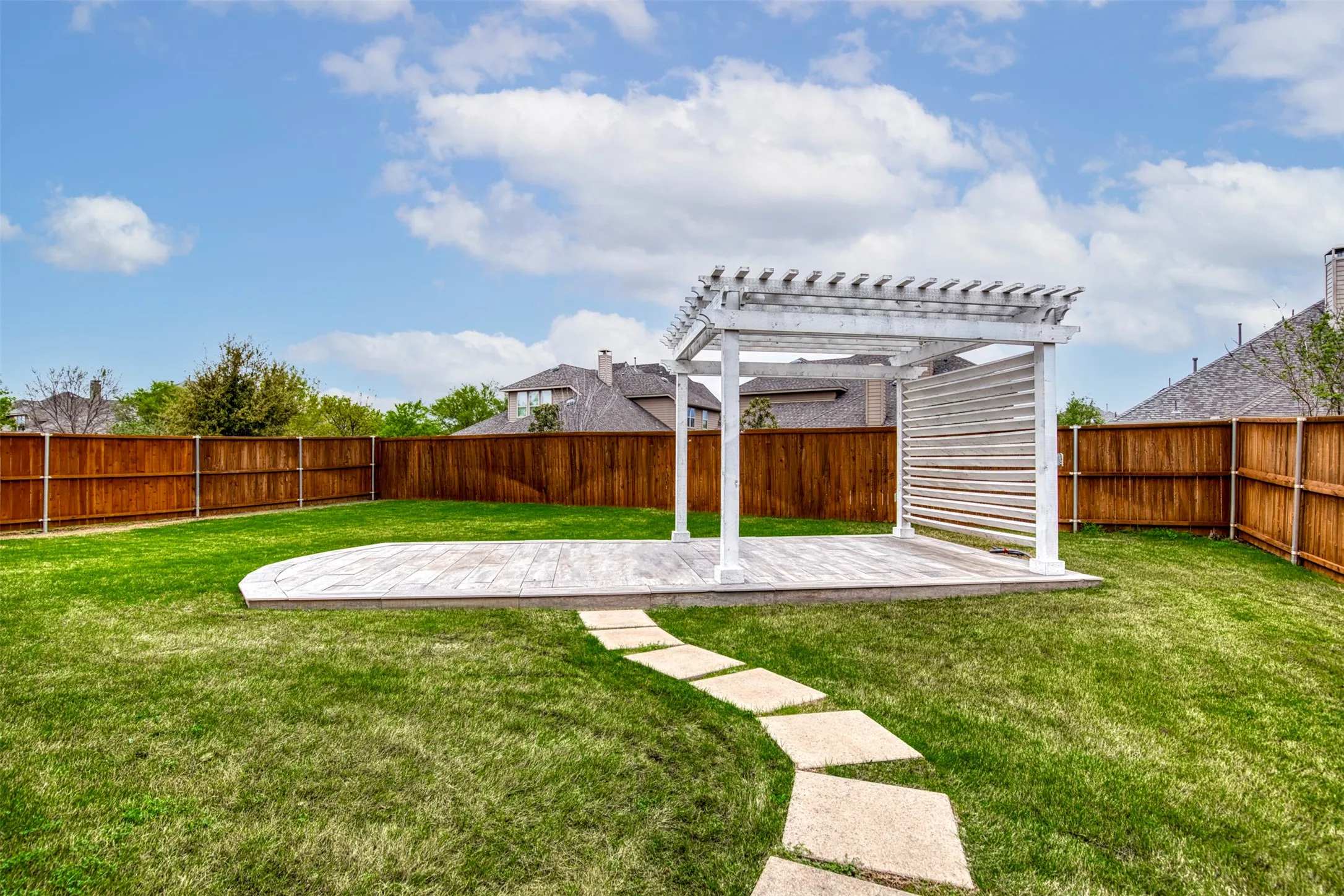 Grassy backyard with pavilion and deck. Perfect for a hot tub!