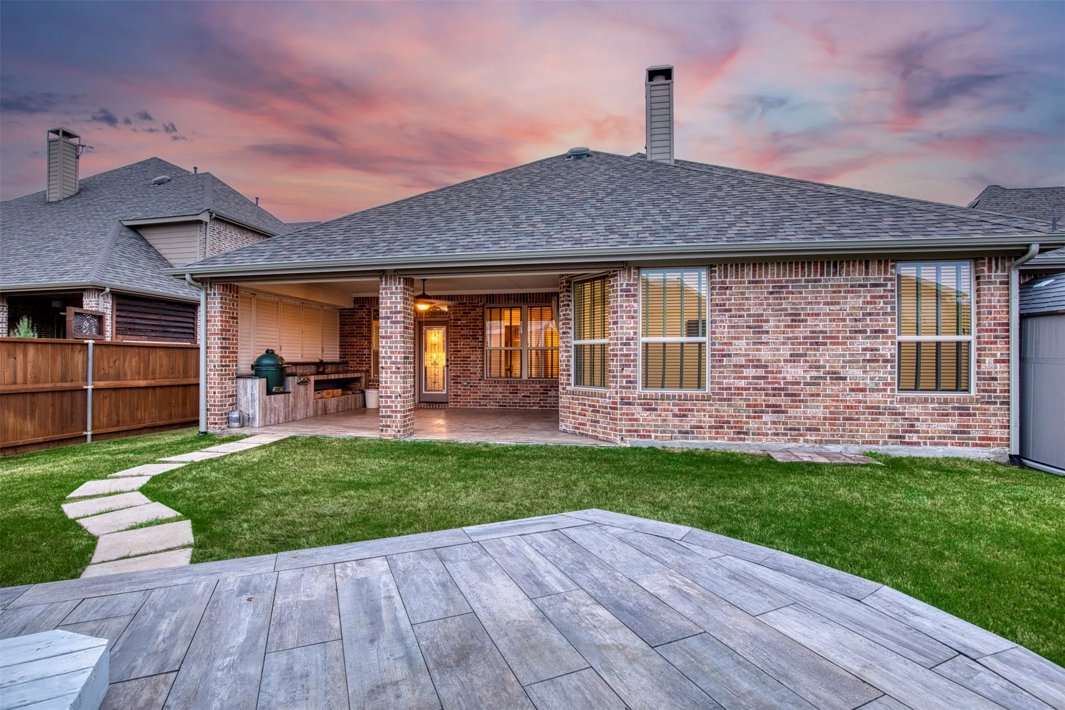 Backyard features large covered patio with outdoor kitchen.