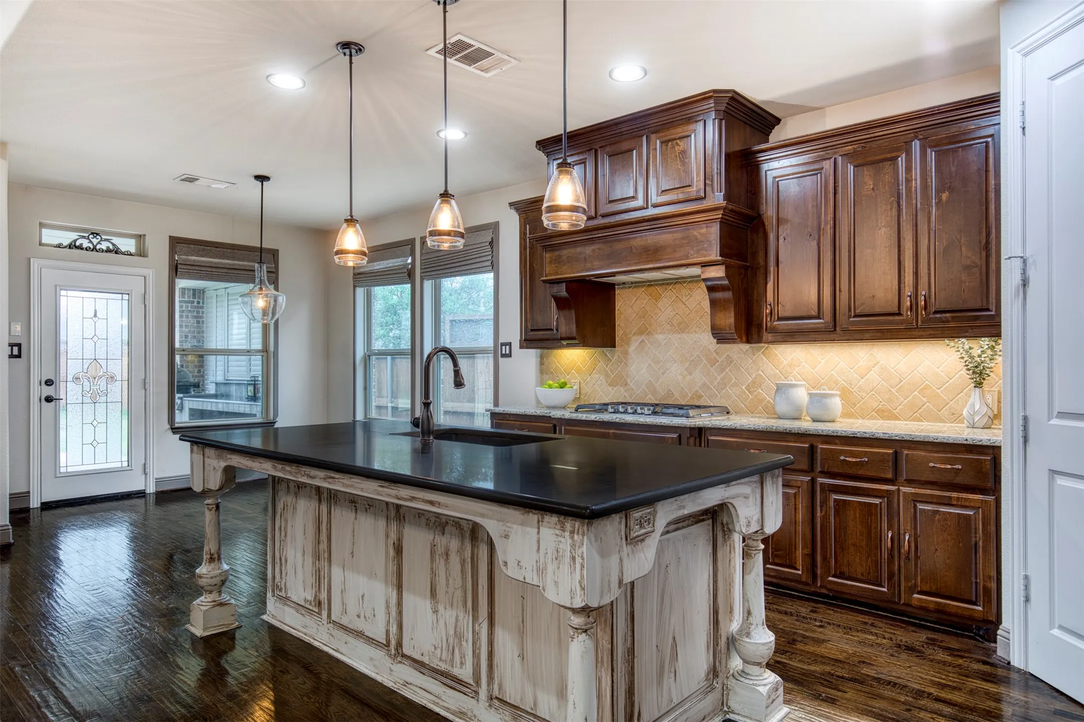 Kitchen with stunning island with pendant lighting.