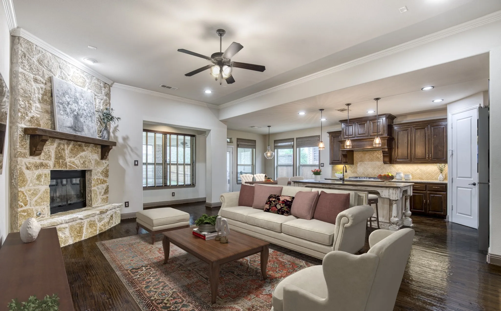 Spacious living room anchored by a floor-to-ceiling stone fireplace.