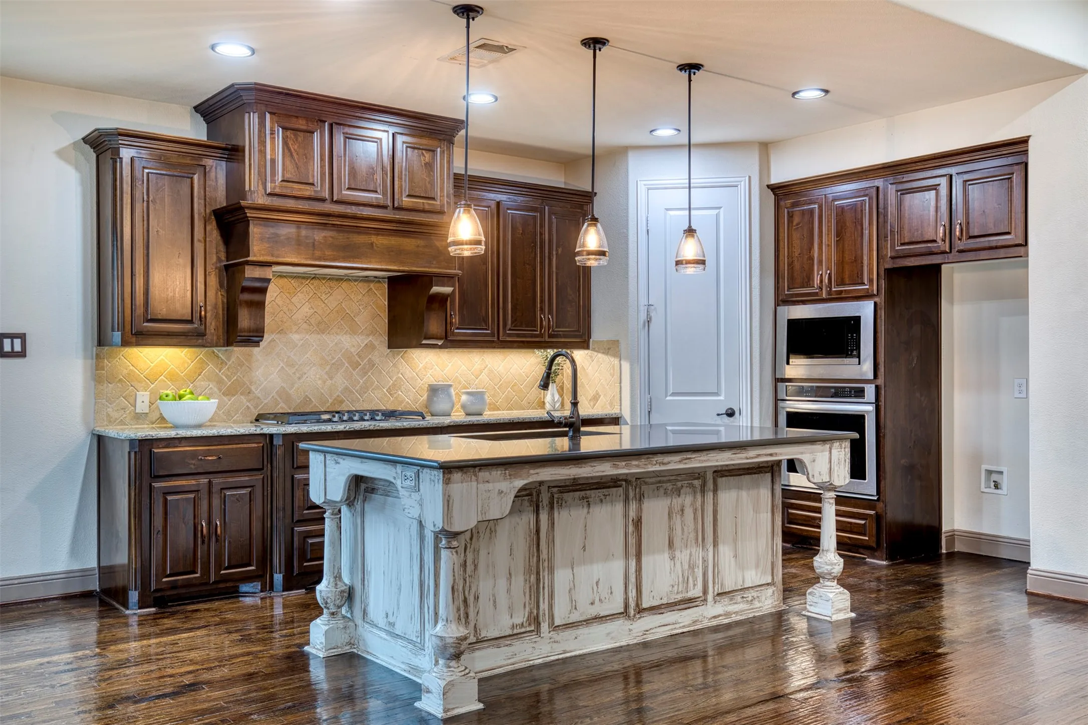 Kitchen features rich wood cabinetry.