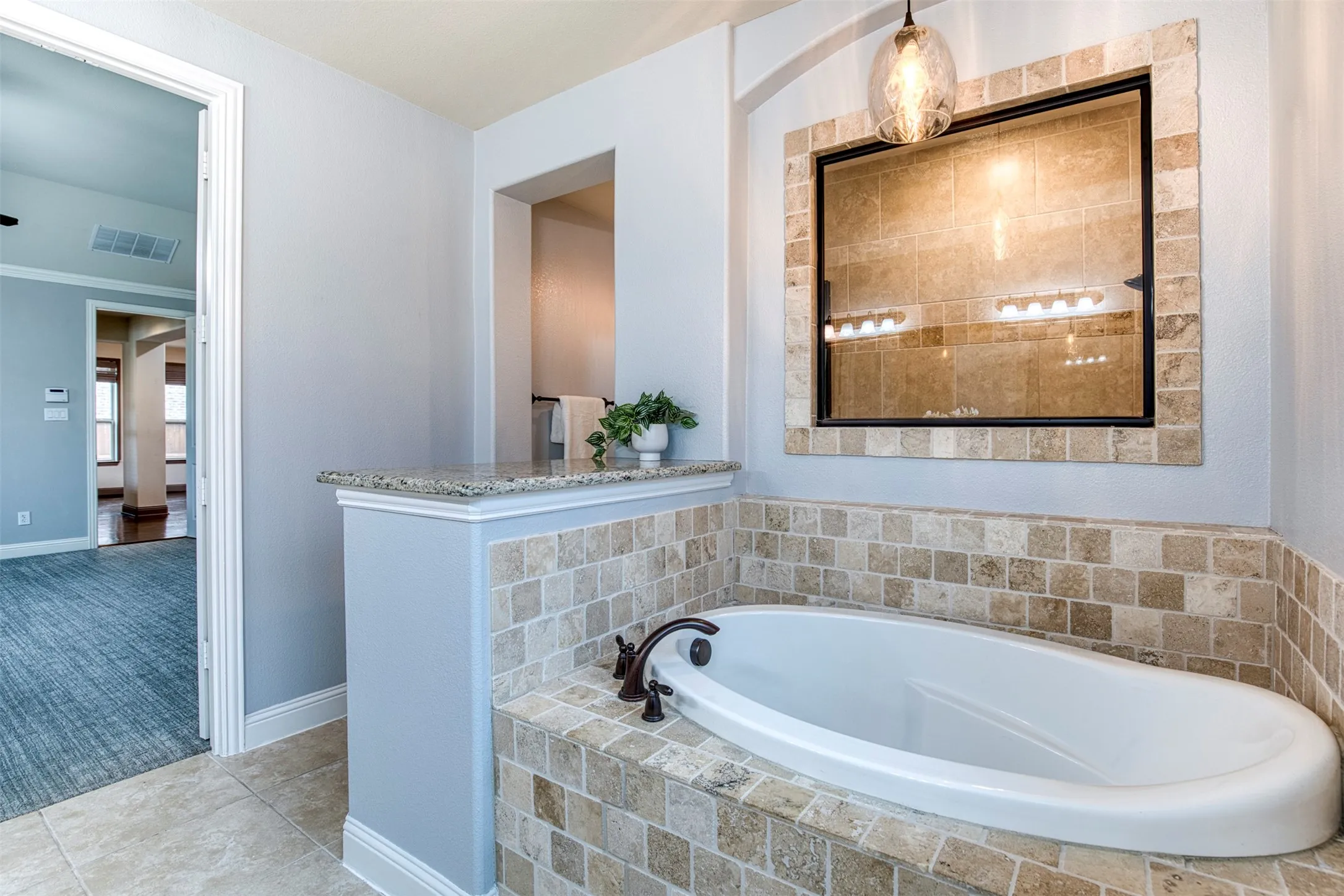 En-suite bath with soaking tub and oversized walk-in shower.