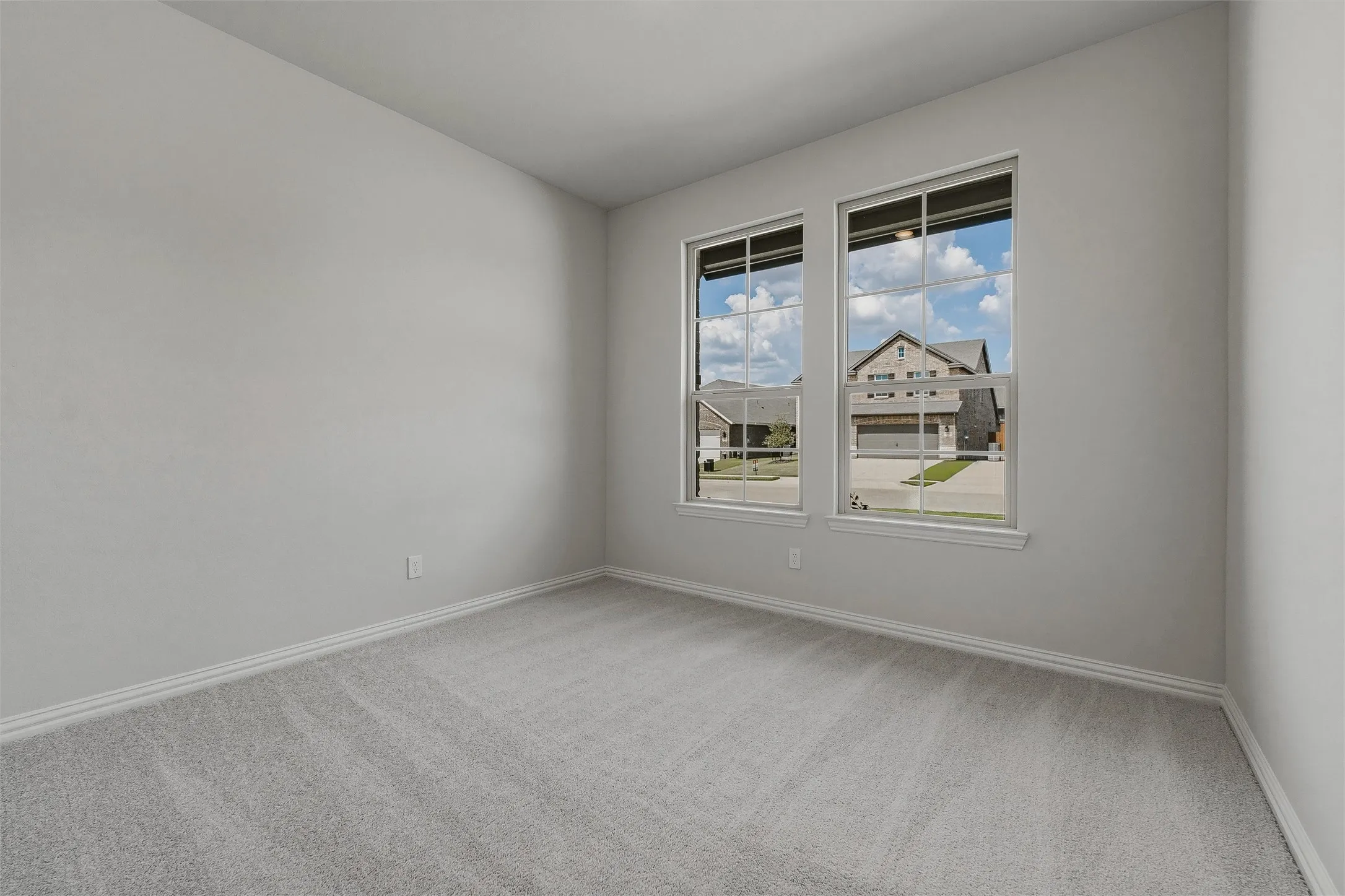 Neutral wall paint and plush carpet flooring