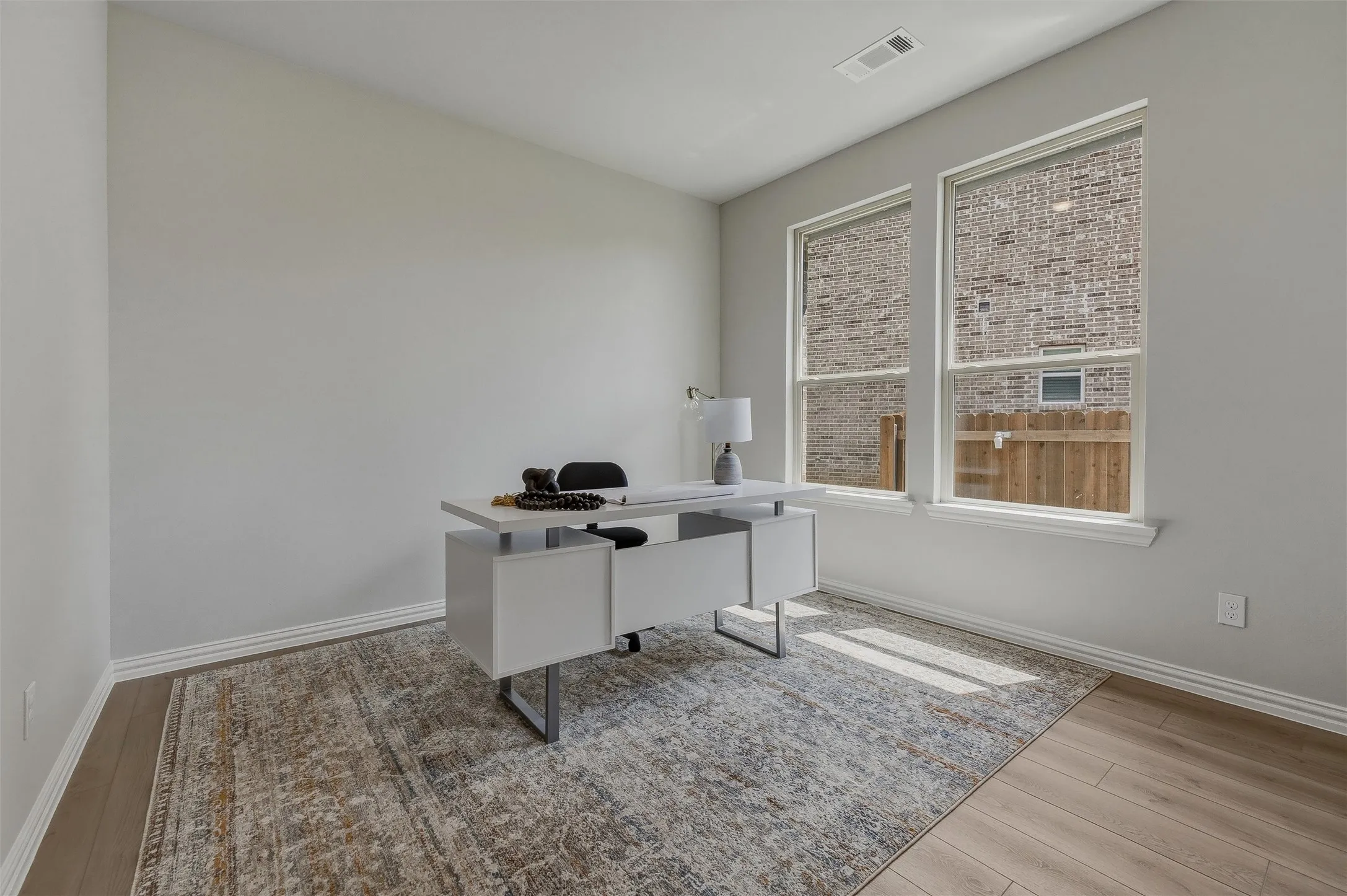 Light-toned walls, wood-finish flooring, and white trim