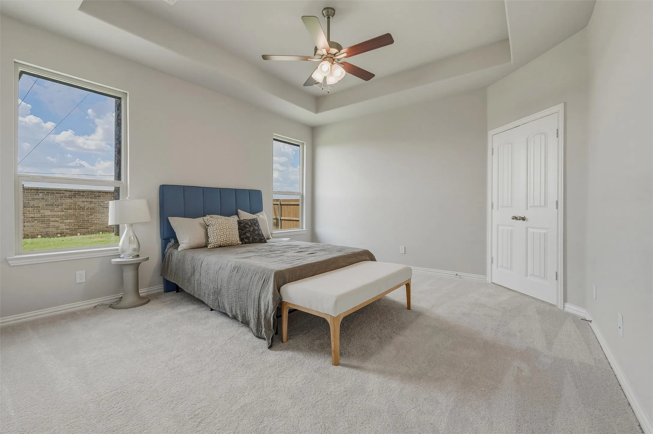 Tray ceiling with recessed lighting and a ceiling fan