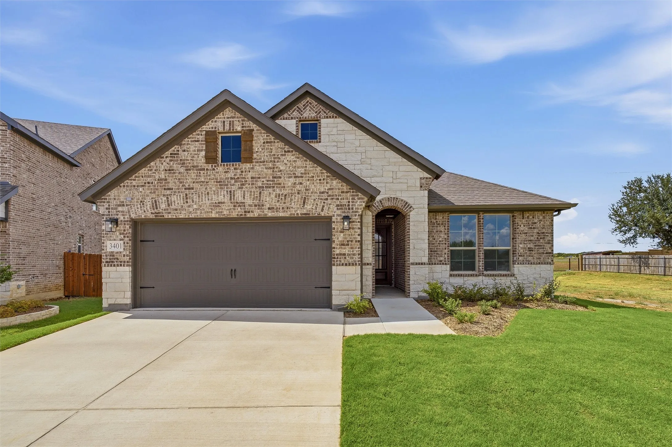 Brick and stone veneer exterior with an arched entryway