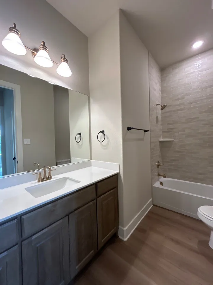 Vanity with a white countertop and integrated sink