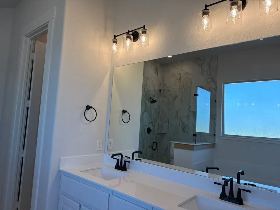 Dual vanity with white countertops and undermount sinks