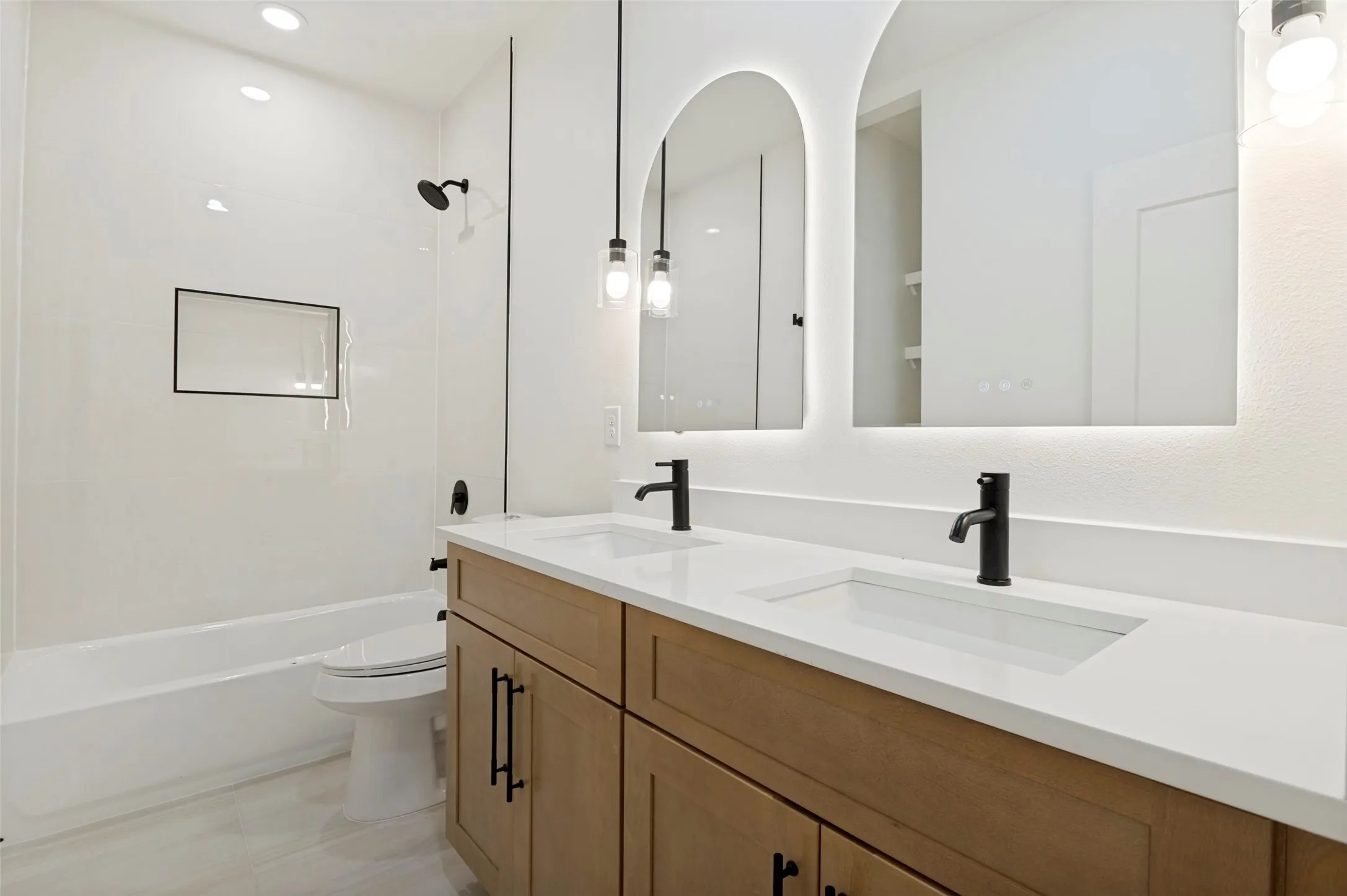 Double vanity featuring stone countertops and integrated sinks