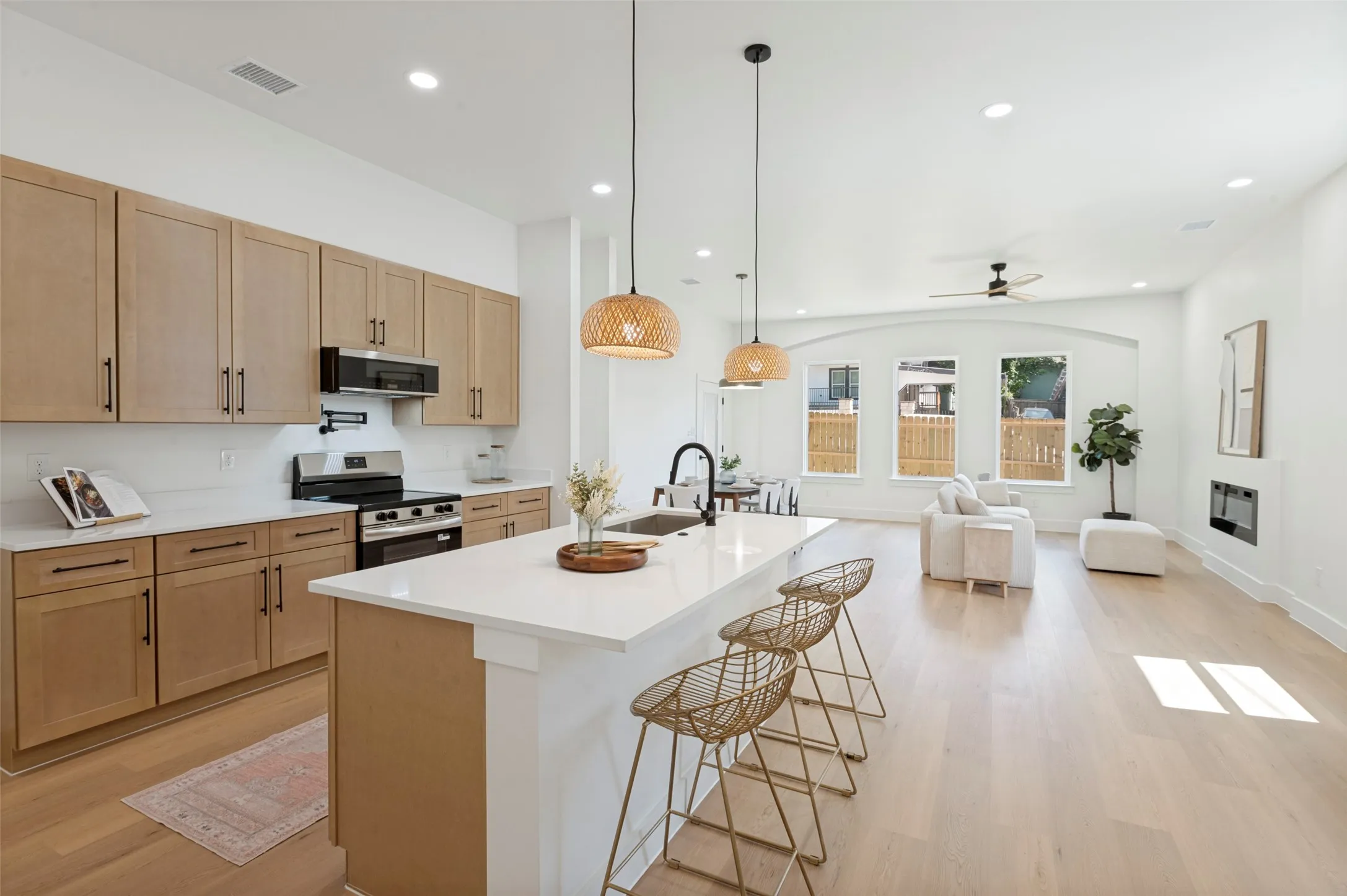 Open-concept living space with light wood-finish flooring