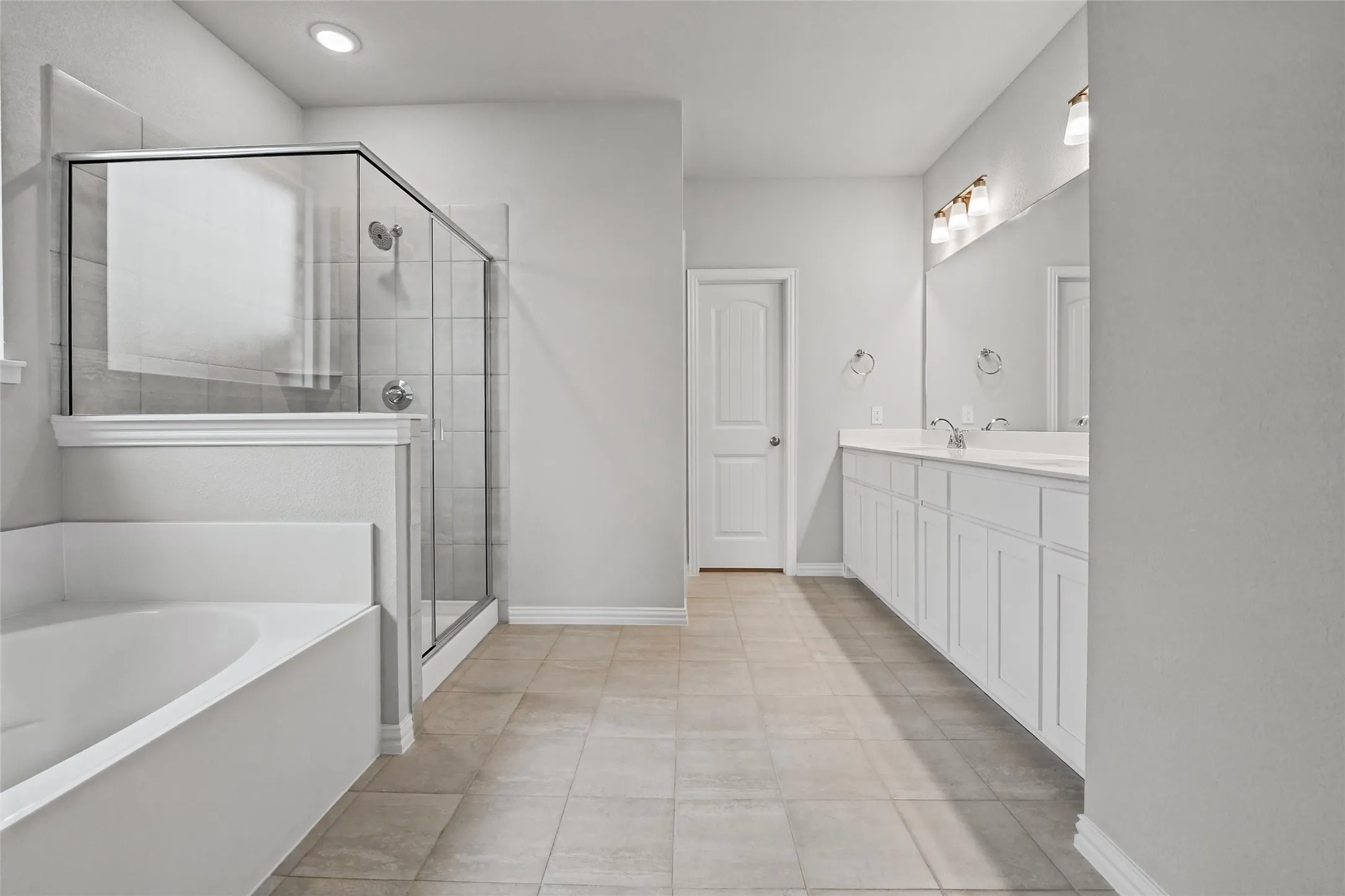 Dual vanity with integrated sinks, framed mirror, and overhead lighting