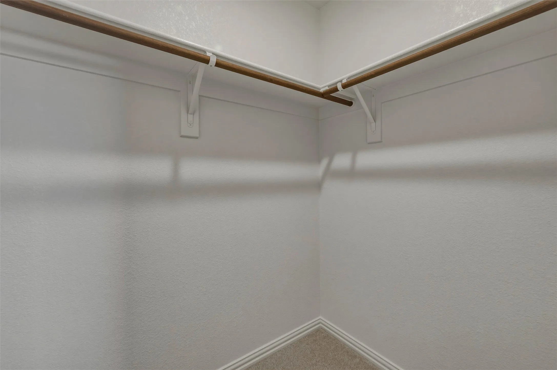 Built-in wood-finish hanging rods with white supports