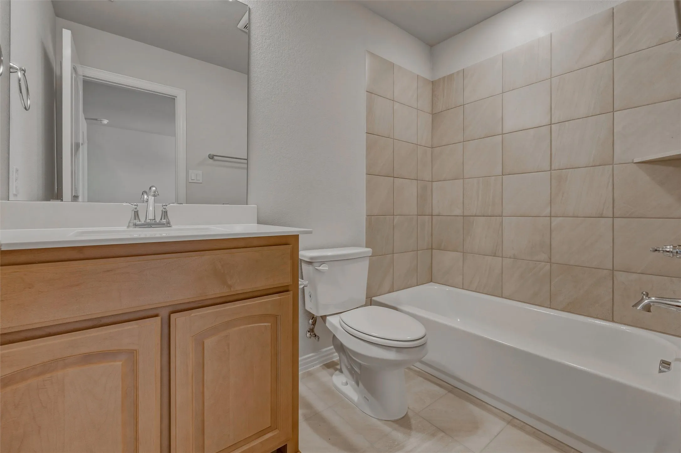 Wood-finish vanity with an integrated sink and chrome faucet