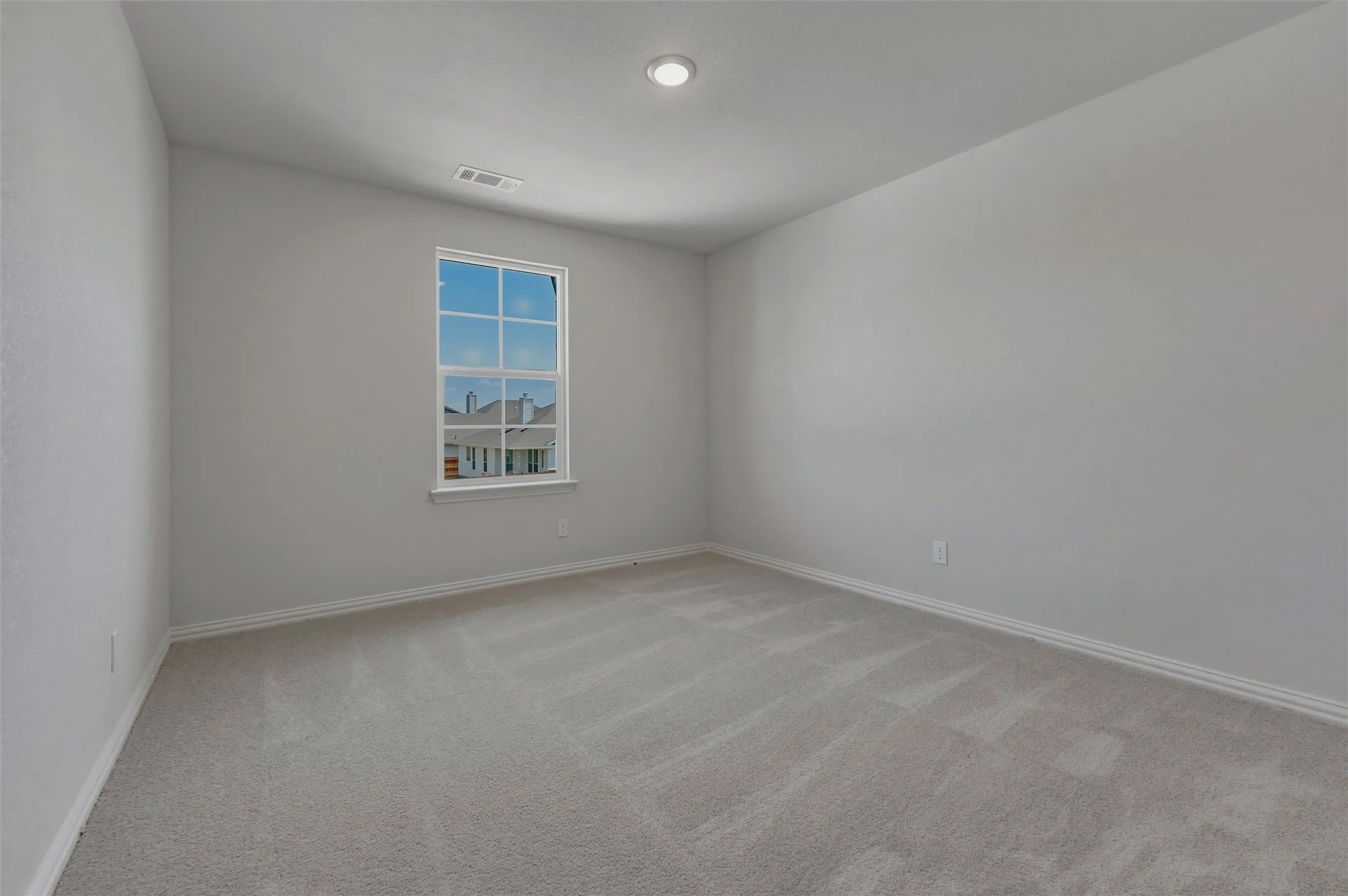 Recessed ceiling lighting, light gray wall finish, white window trim, white baseboards, and gray carpet flooring
