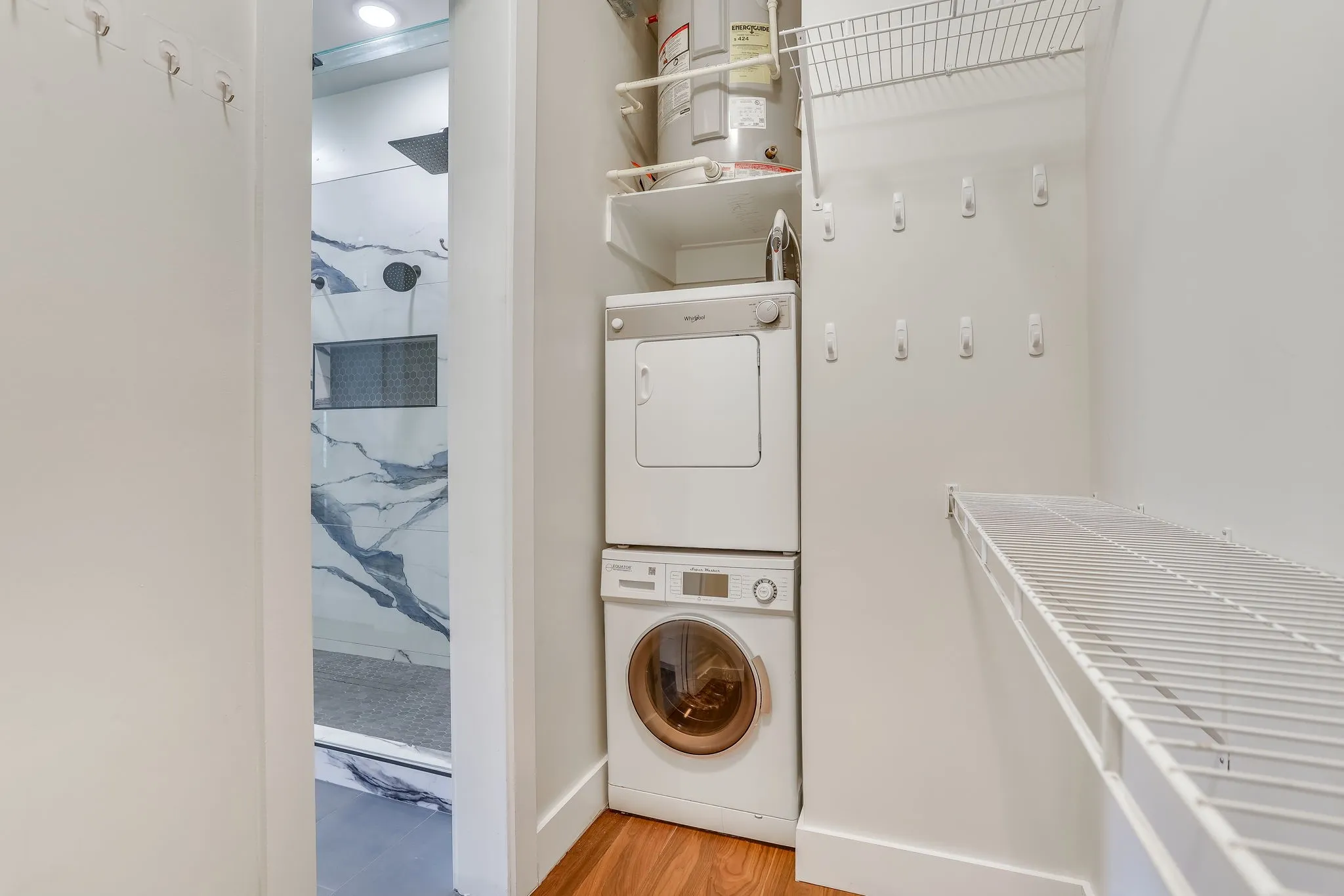Conveniently tucked within the spacious closet, the integrated laundry area features a stacked washer and dryer for effortless everyday living.