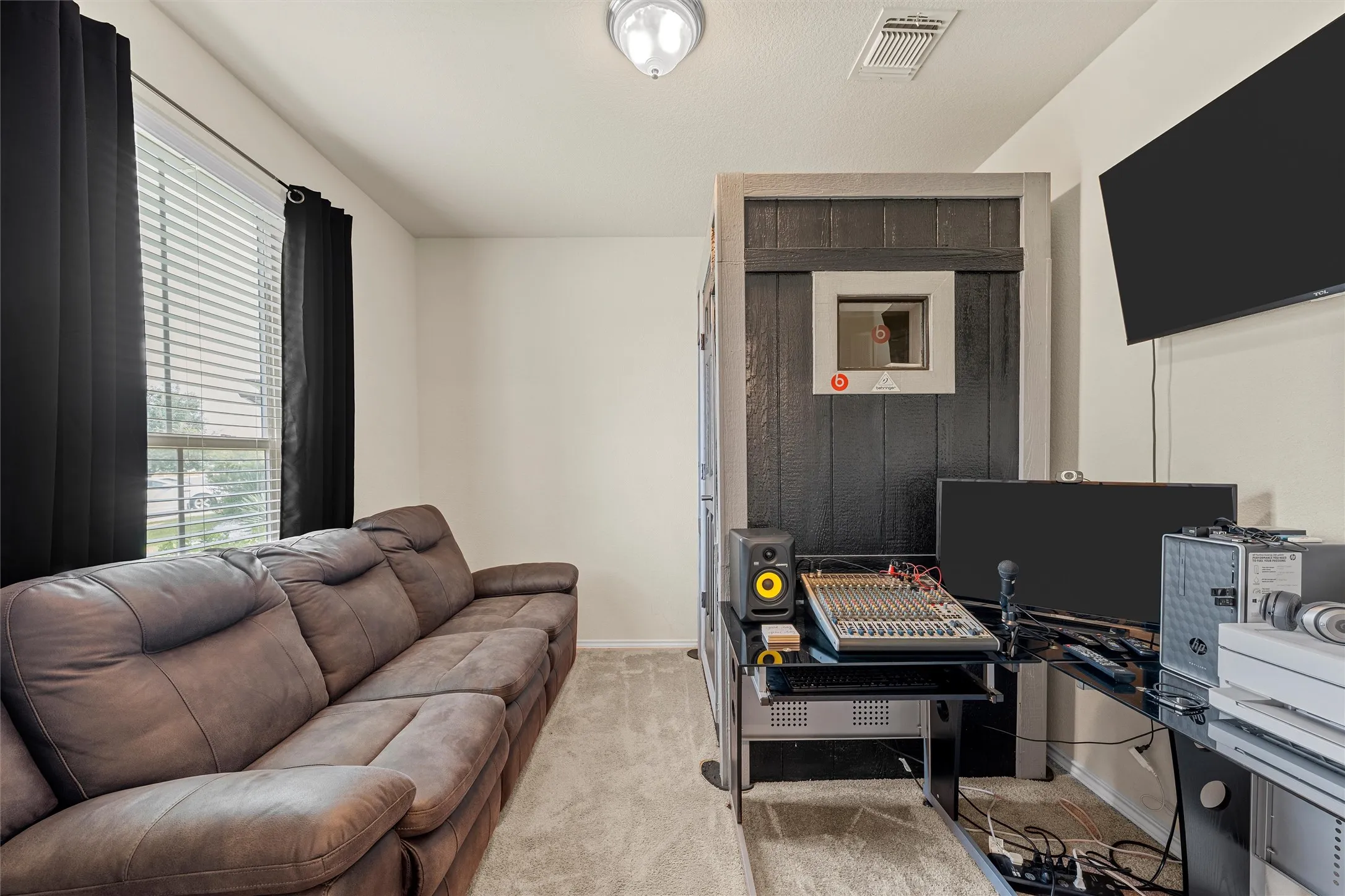 Dedicated studio booth with a clear viewing panel