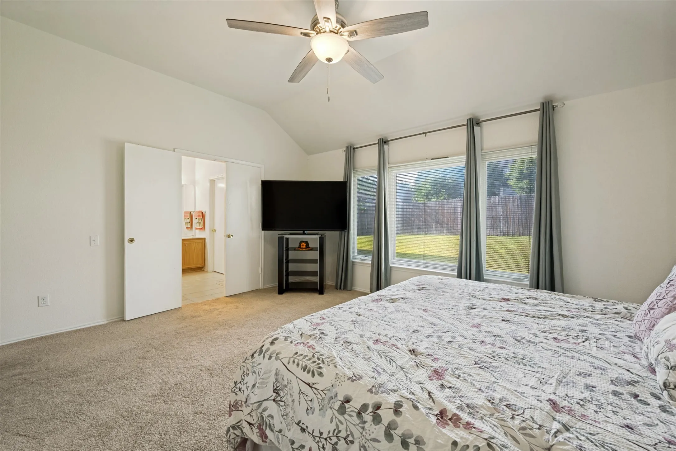 Primary bedroom overlooking the backyard with an ensuite bath