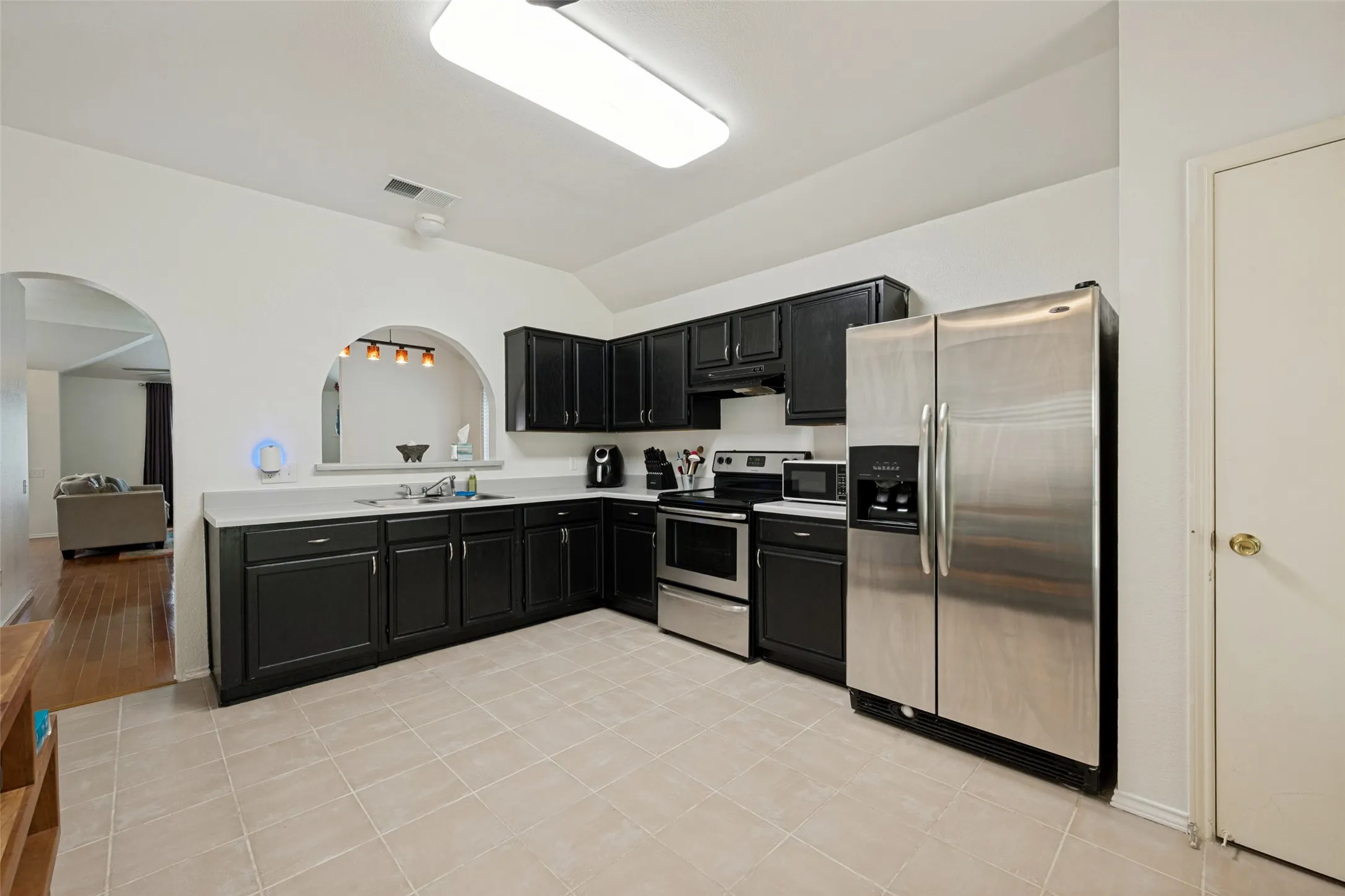 Kitchen with cute arched window to the dining area