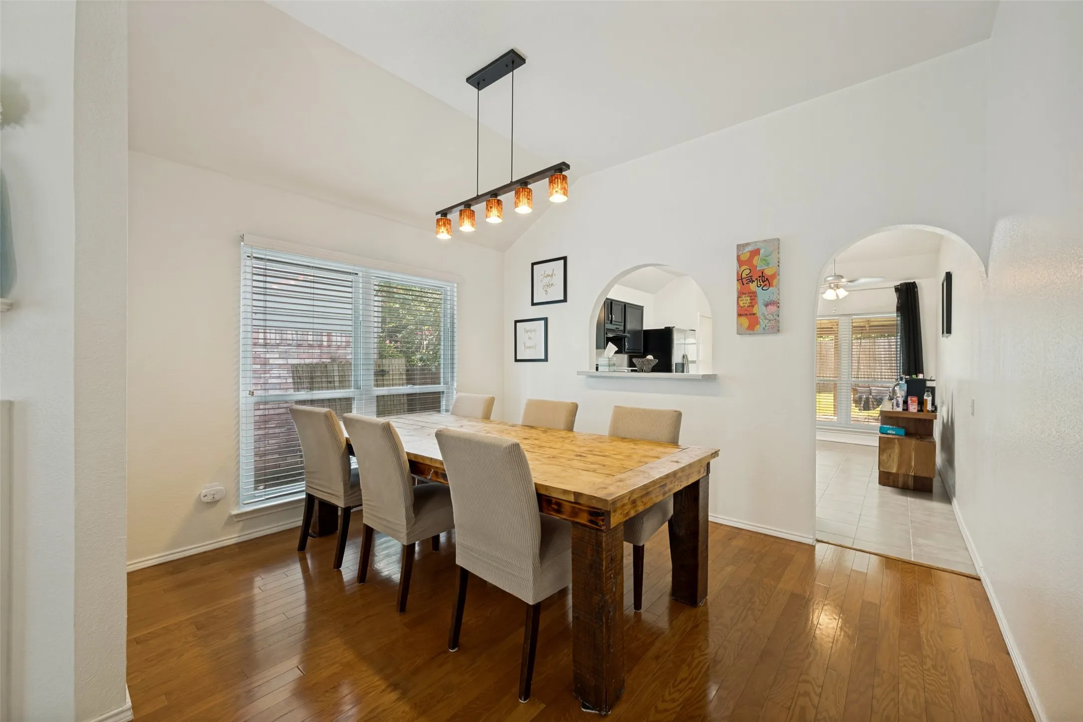 Dining area with cute arched window to the kitchen